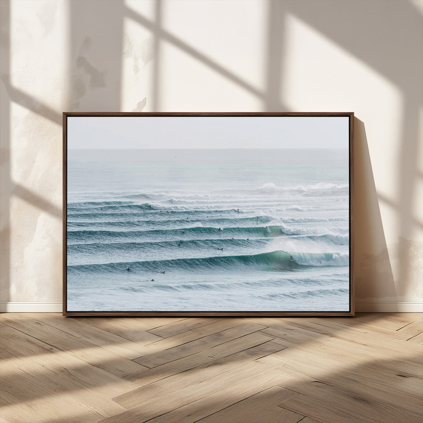 High-angle view of surfers lining up across layered ocean waves, ideal for minimal coastal or surf-inspired room decor.
