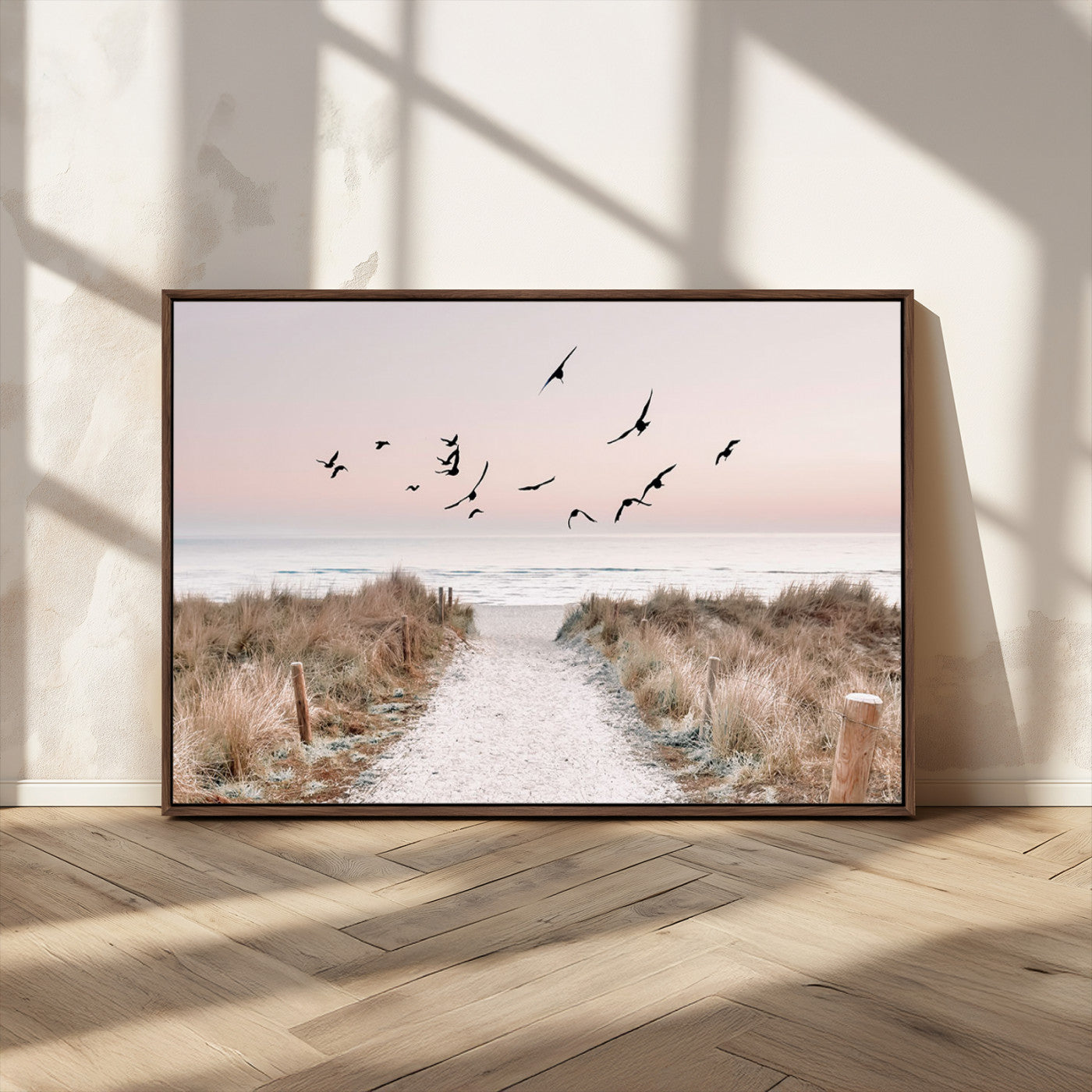 A peaceful coastal pathway leading to the ocean, with birds flying across a soft pastel sky, creating a calm and scenic beach atmosphere.