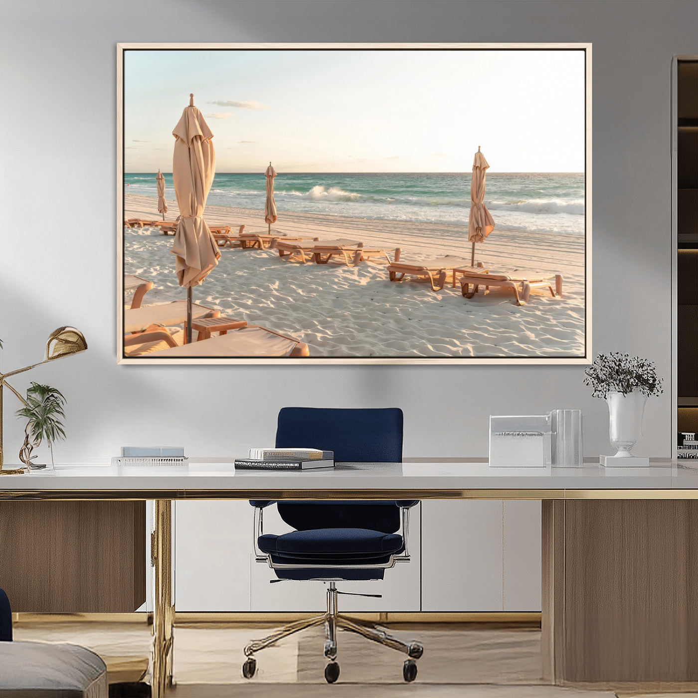 Minimalist photo of empty beach loungers and umbrellas on soft sand, ideal for calm seaside or pastel coastal-style home decor.