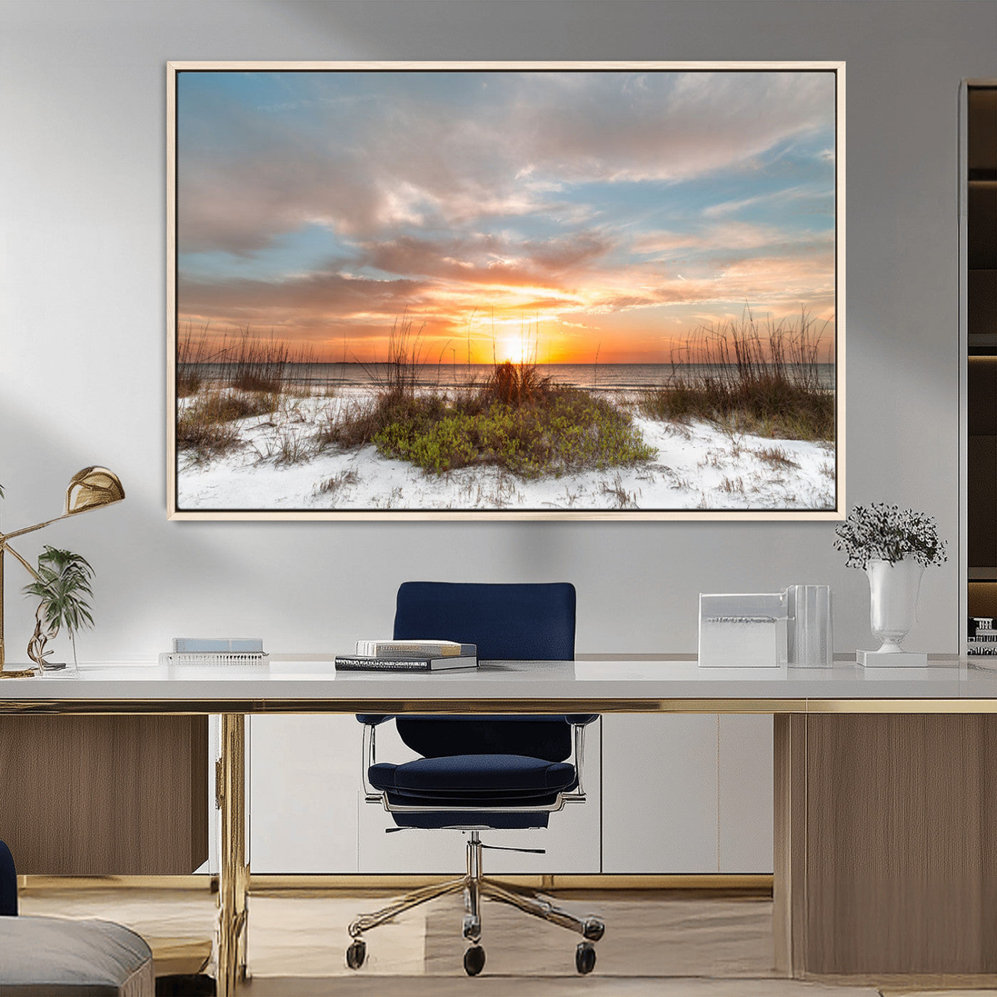 A tranquil beach scene featuring golden sunset hues over the water, with grasses in the foreground and a peaceful, serene atmosphere.