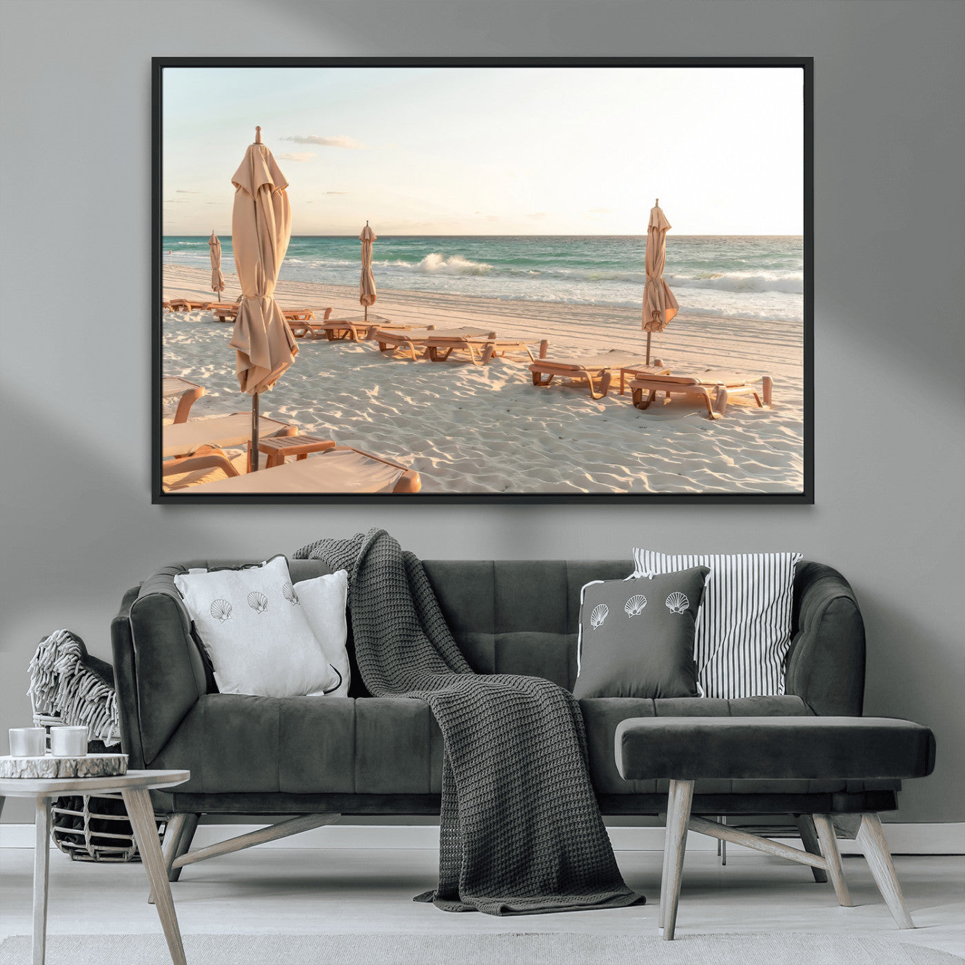 Minimalist photo of empty beach loungers and umbrellas on soft sand, ideal for calm seaside or pastel coastal-style home decor.