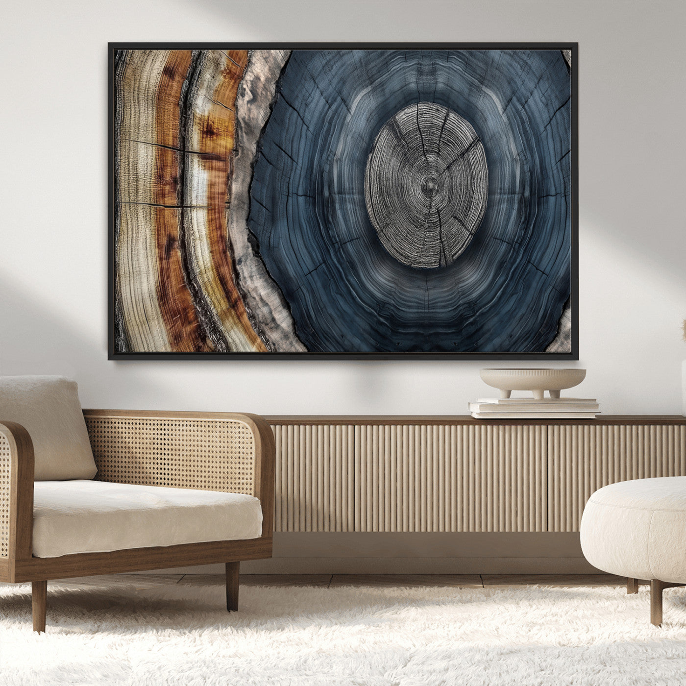 A stunning close-up of a tree trunk showing the intricate, circular growth rings, showcasing the natural textures and rich contrasts in deep blues, browns, and silvers.