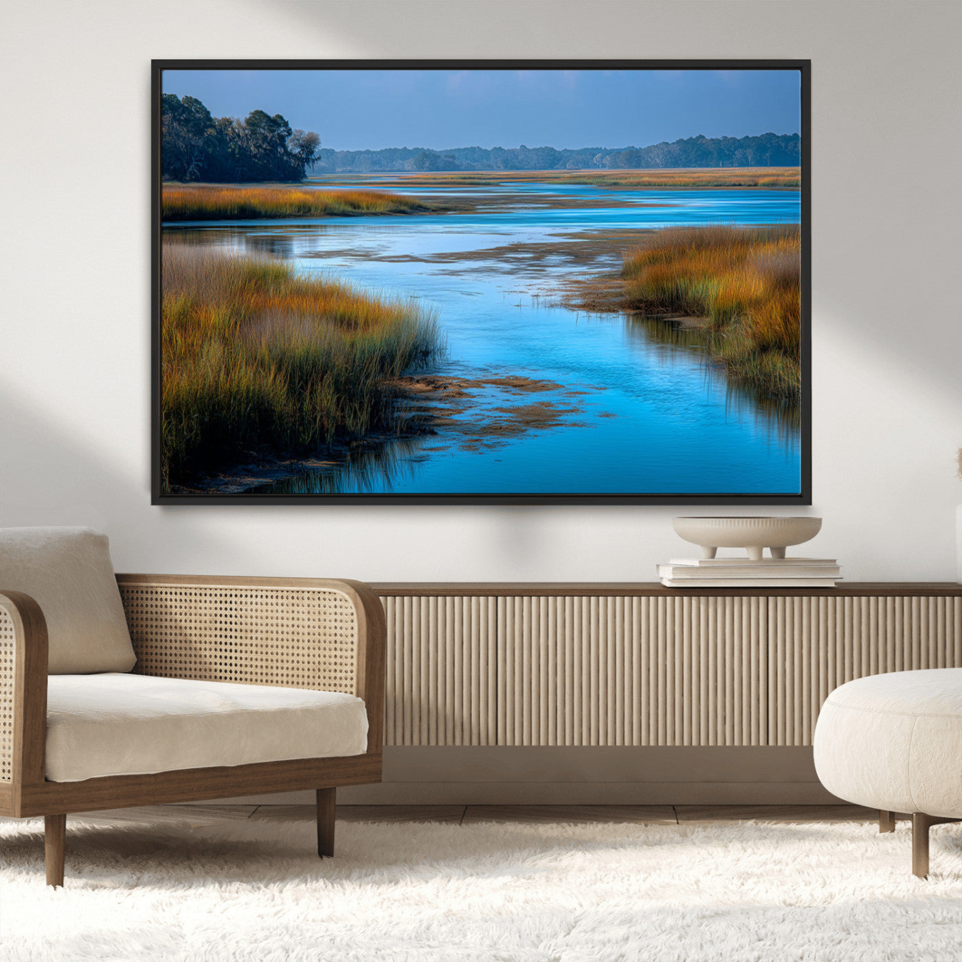 A peaceful marshland scene with calm blue water reflecting the surrounding grasses and trees, capturing the beauty of nature in a serene landscape.