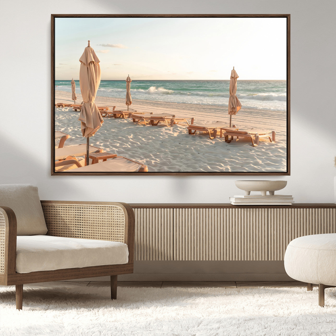 Minimalist photo of empty beach loungers and umbrellas on soft sand, ideal for calm seaside or pastel coastal-style home decor.