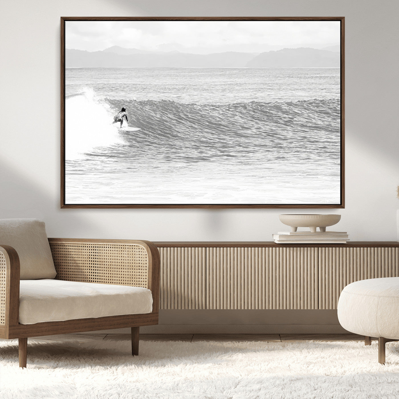 Monochrome photo of a surfer riding a wave with distant mountains, ideal for coastal motion or black and white surf-themed wall decor.