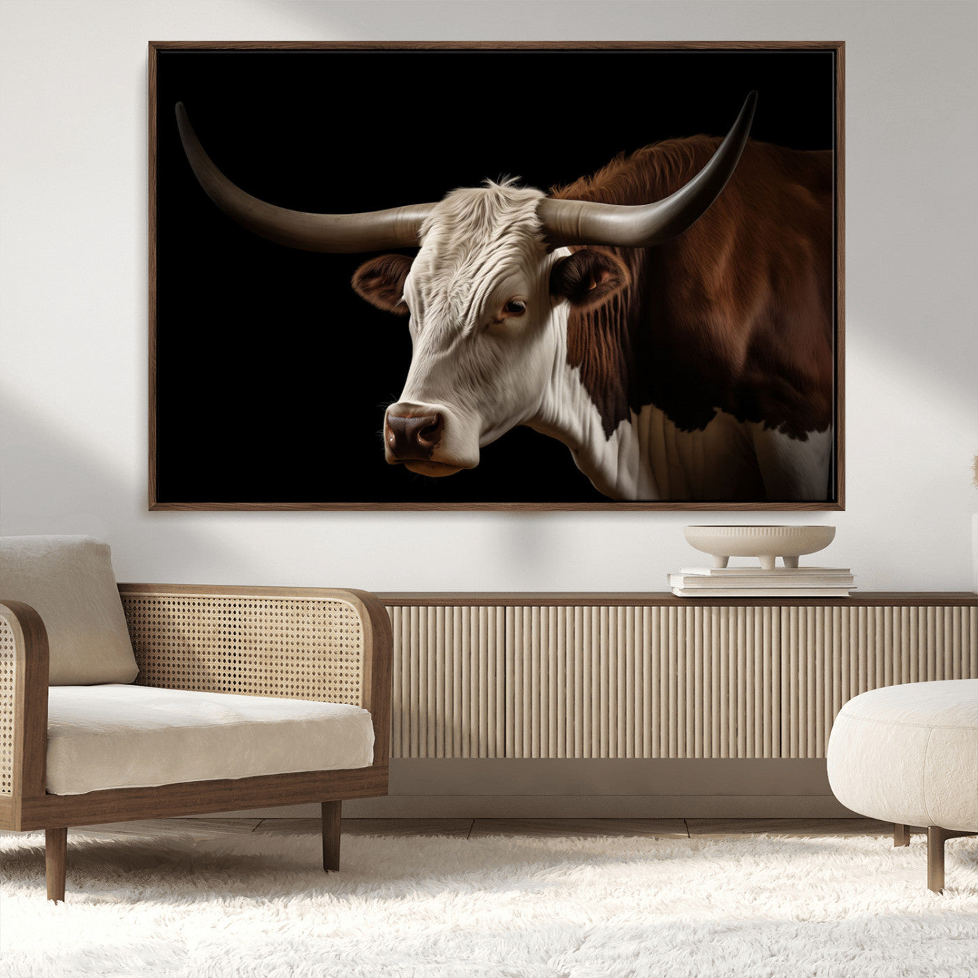 "Close-up of a brown and white longhorn cow with prominent curved horns against a black background."