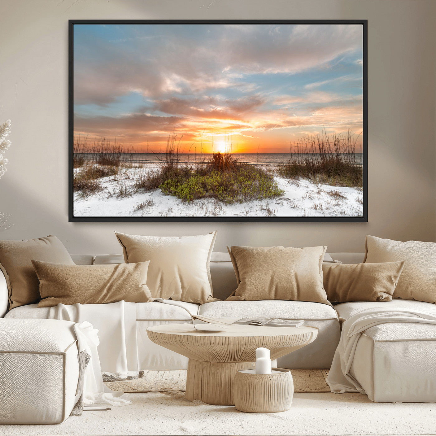 A tranquil beach scene featuring golden sunset hues over the water, with grasses in the foreground and a peaceful, serene atmosphere.