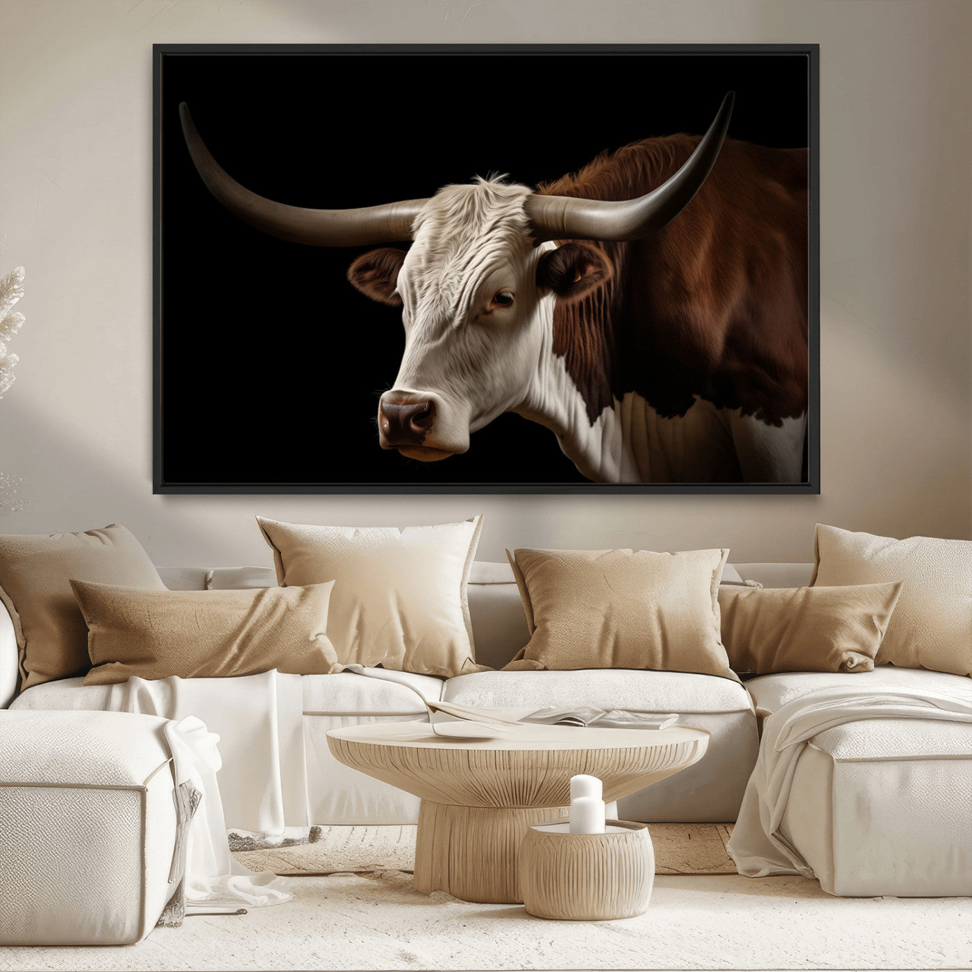 "Close-up of a brown and white longhorn cow with prominent curved horns against a black background."