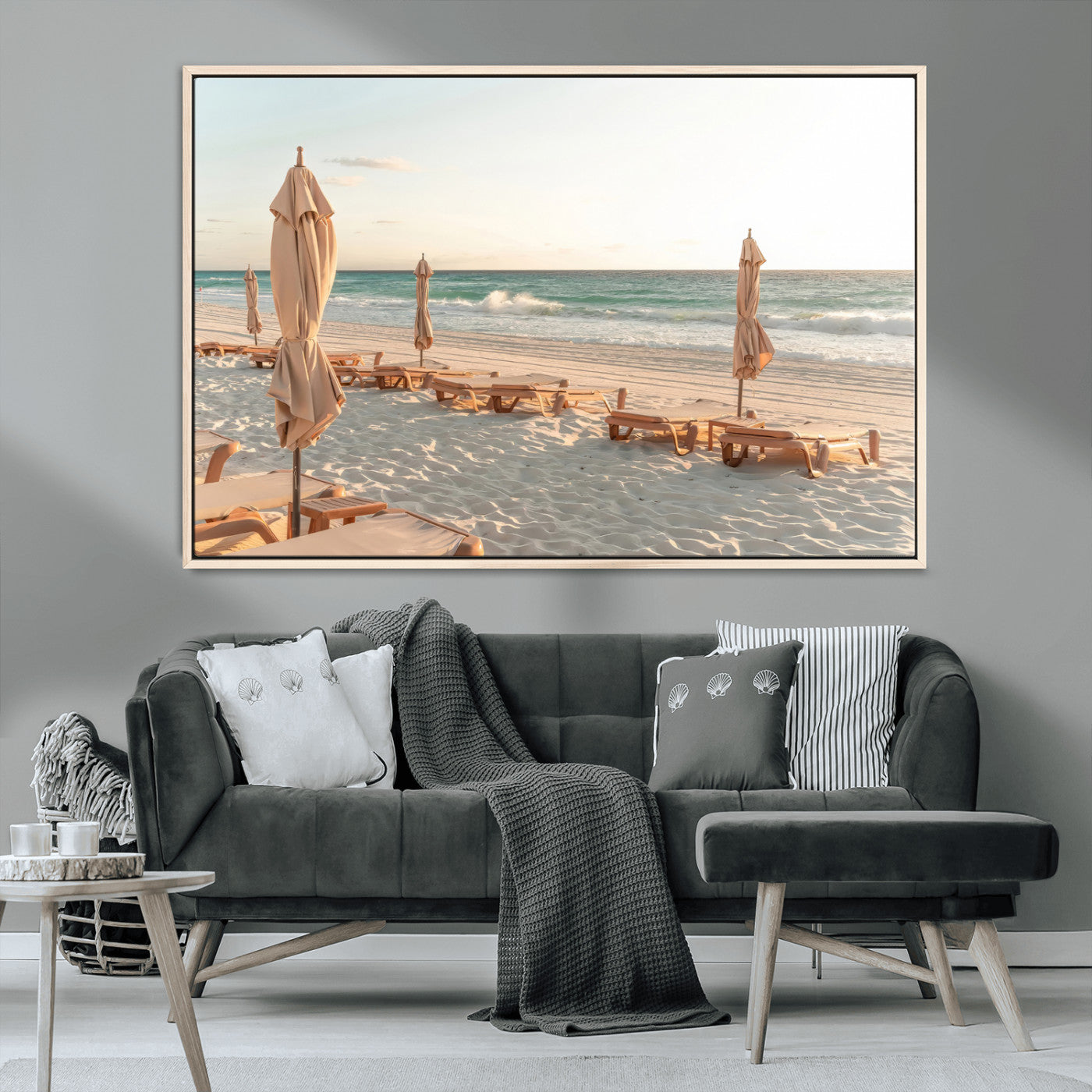 Minimalist photo of empty beach loungers and umbrellas on soft sand, ideal for calm seaside or pastel coastal-style home decor.