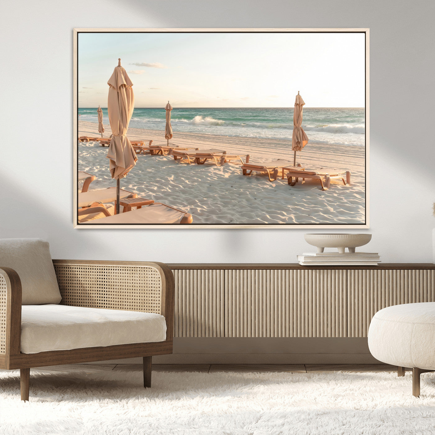 Minimalist photo of empty beach loungers and umbrellas on soft sand, ideal for calm seaside or pastel coastal-style home decor.