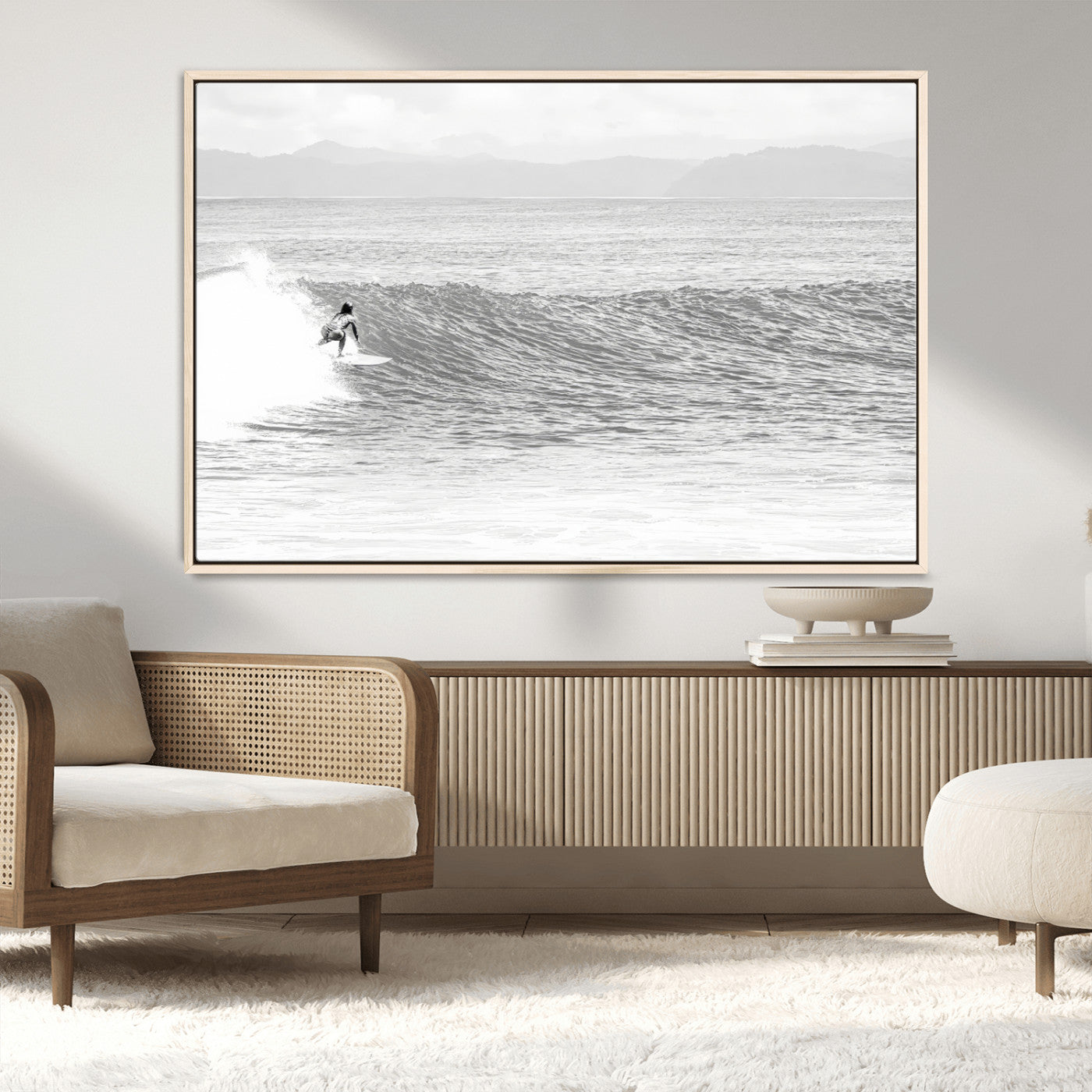 Monochrome photo of a surfer riding a wave with distant mountains, ideal for coastal motion or black and white surf-themed wall decor.