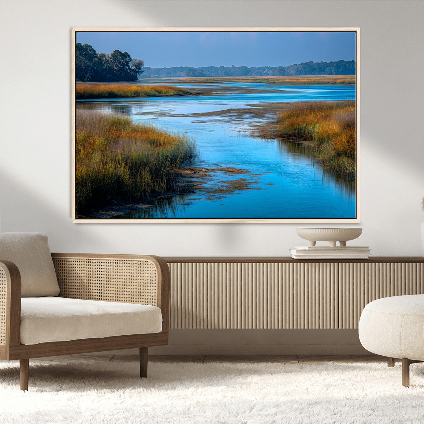 A peaceful marshland scene with calm blue water reflecting the surrounding grasses and trees, capturing the beauty of nature in a serene landscape.