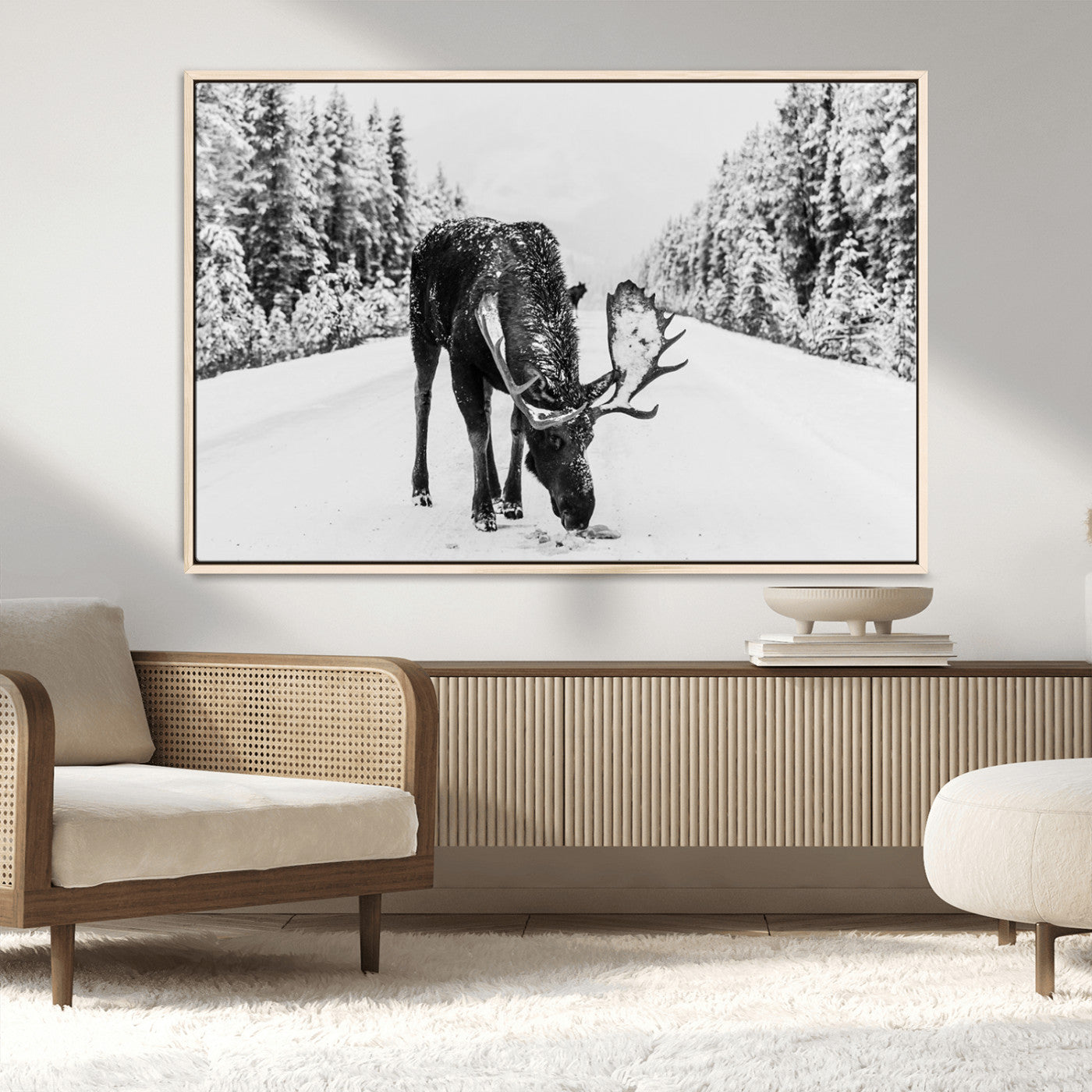 A majestic moose grazing in the snow-covered wilderness, surrounded by snow-covered trees, creating a peaceful winter scene.