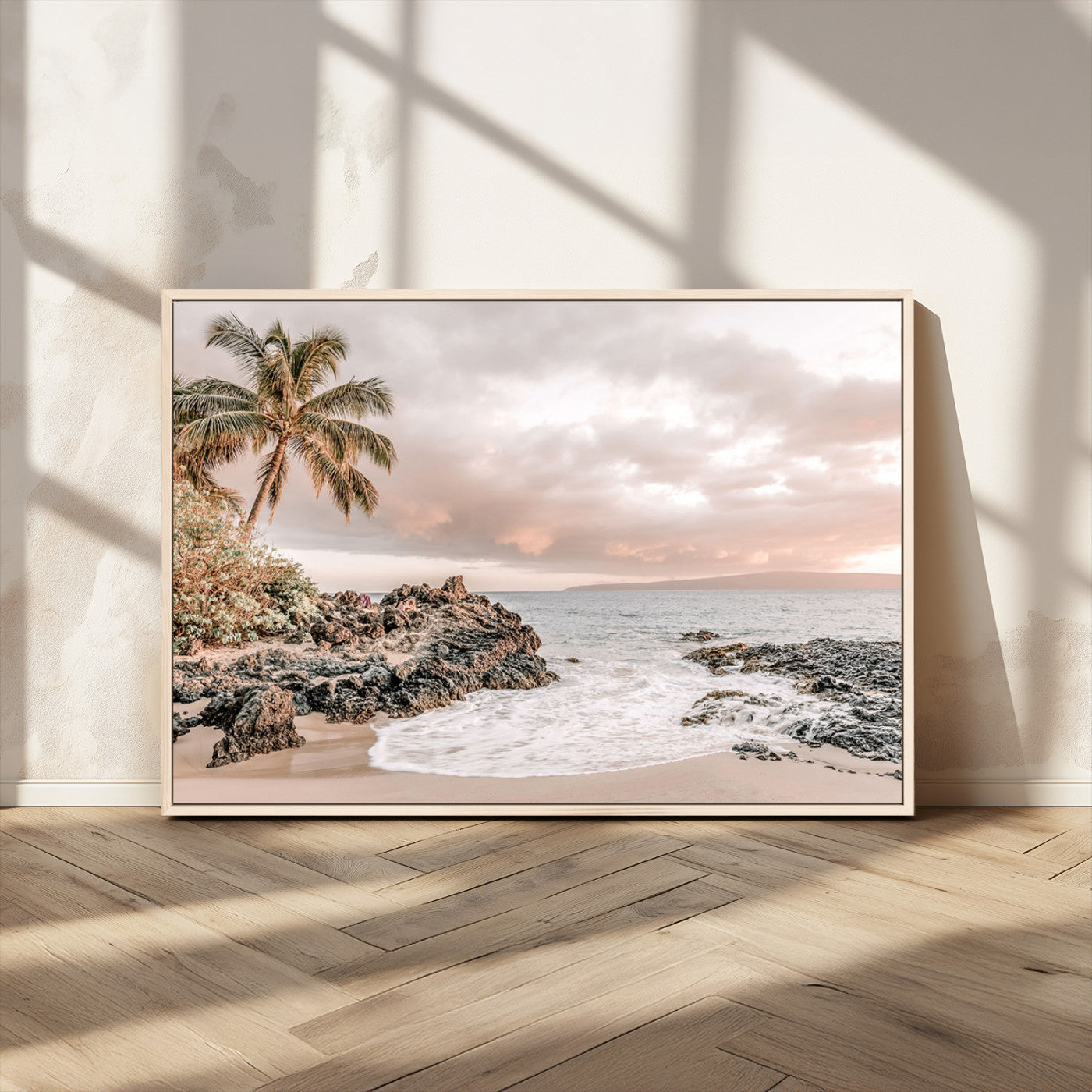 A peaceful beach scene with a palm tree and rocks, soft waves washing onto the shore under a soft pastel sky at sunset.