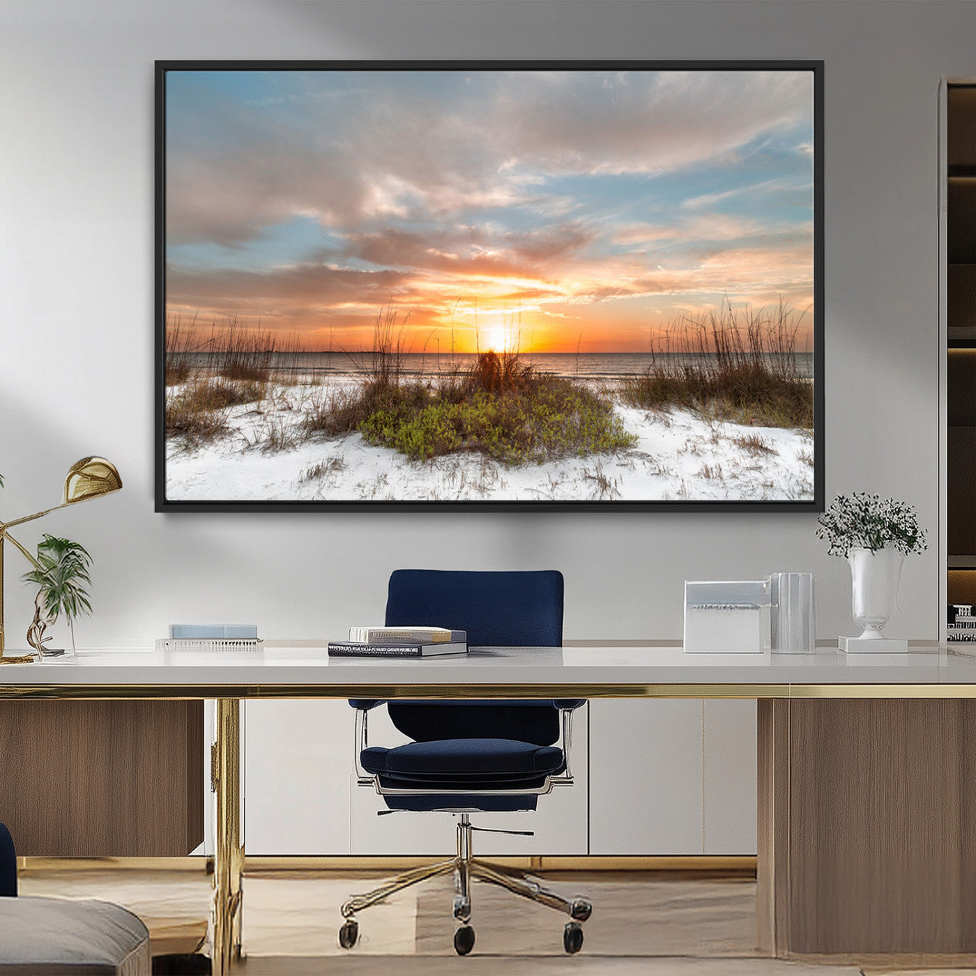 A tranquil beach scene featuring golden sunset hues over the water, with grasses in the foreground and a peaceful, serene atmosphere.