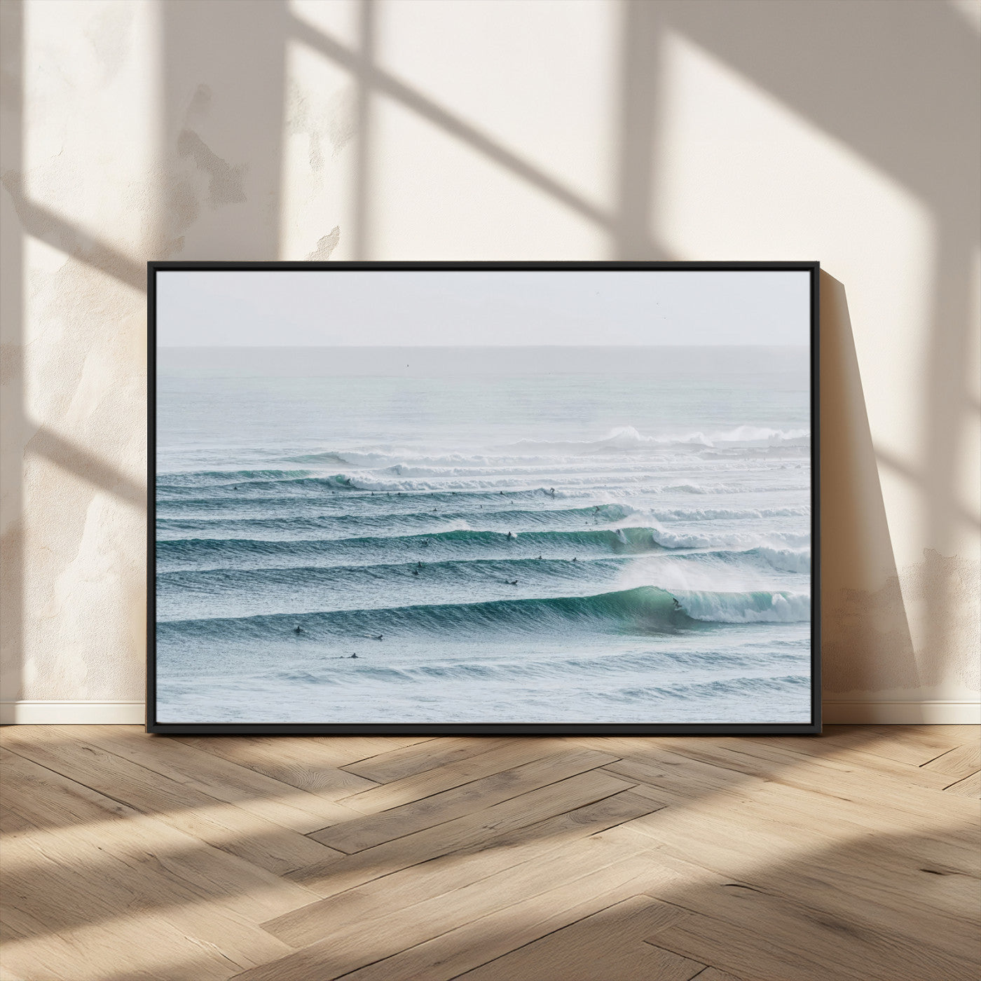 High-angle view of surfers lining up across layered ocean waves, ideal for minimal coastal or surf-inspired room decor.