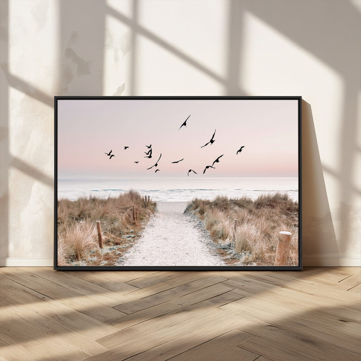 A peaceful coastal pathway leading to the ocean, with birds flying across a soft pastel sky, creating a calm and scenic beach atmosphere.