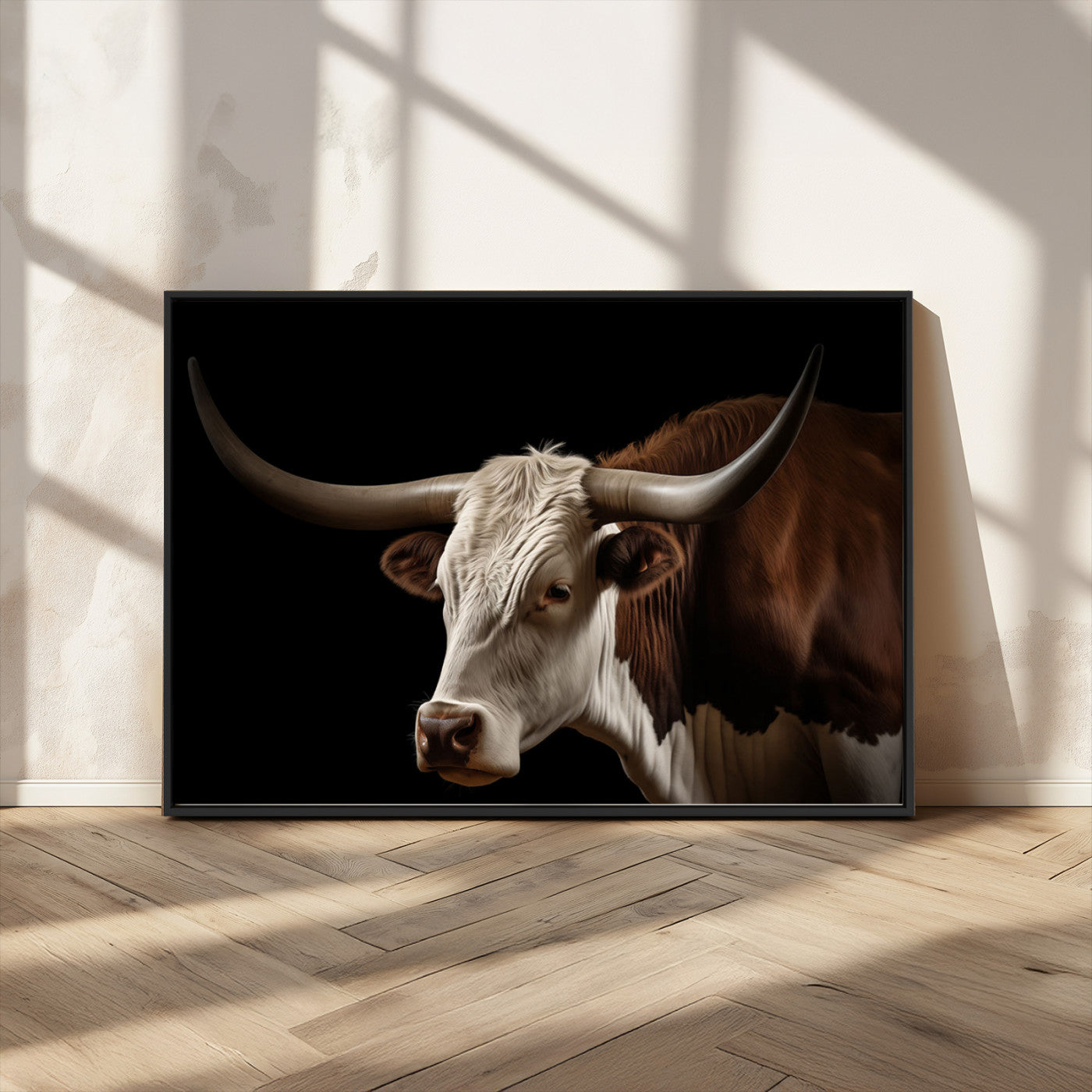 "Close-up of a brown and white longhorn cow with prominent curved horns against a black background."