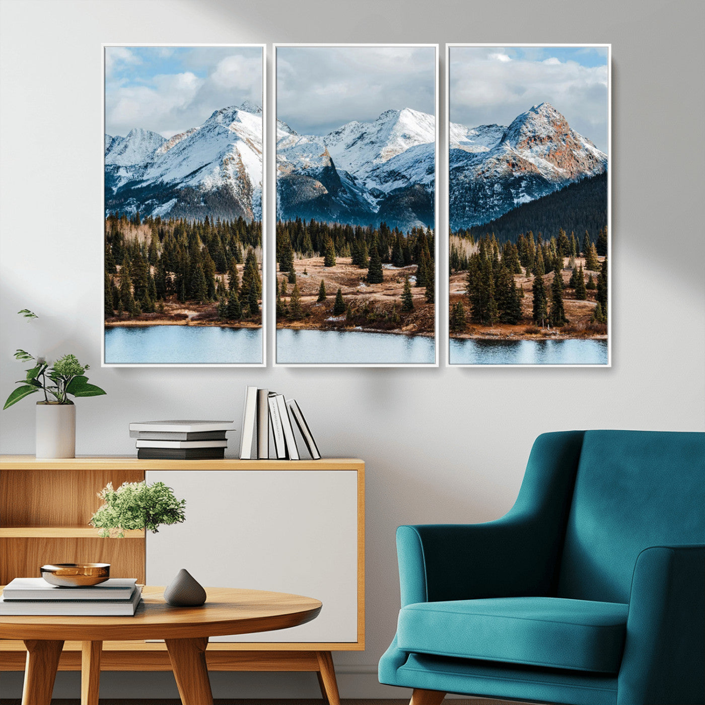 Framed canvas of snowy mountain peaks with pine forest and alpine lake, perfect for winter cabin or wilderness-inspired home decor.