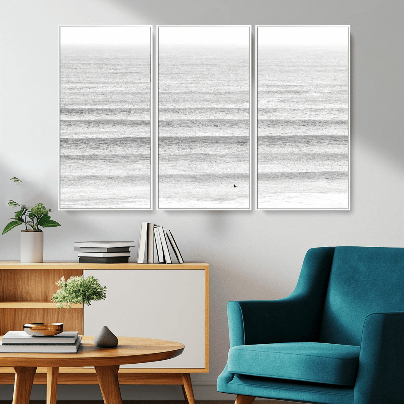 Monochrome photo of a lone surfer in calm layered waves, perfect for minimalist coastal or moody ocean-inspired wall decoration.
