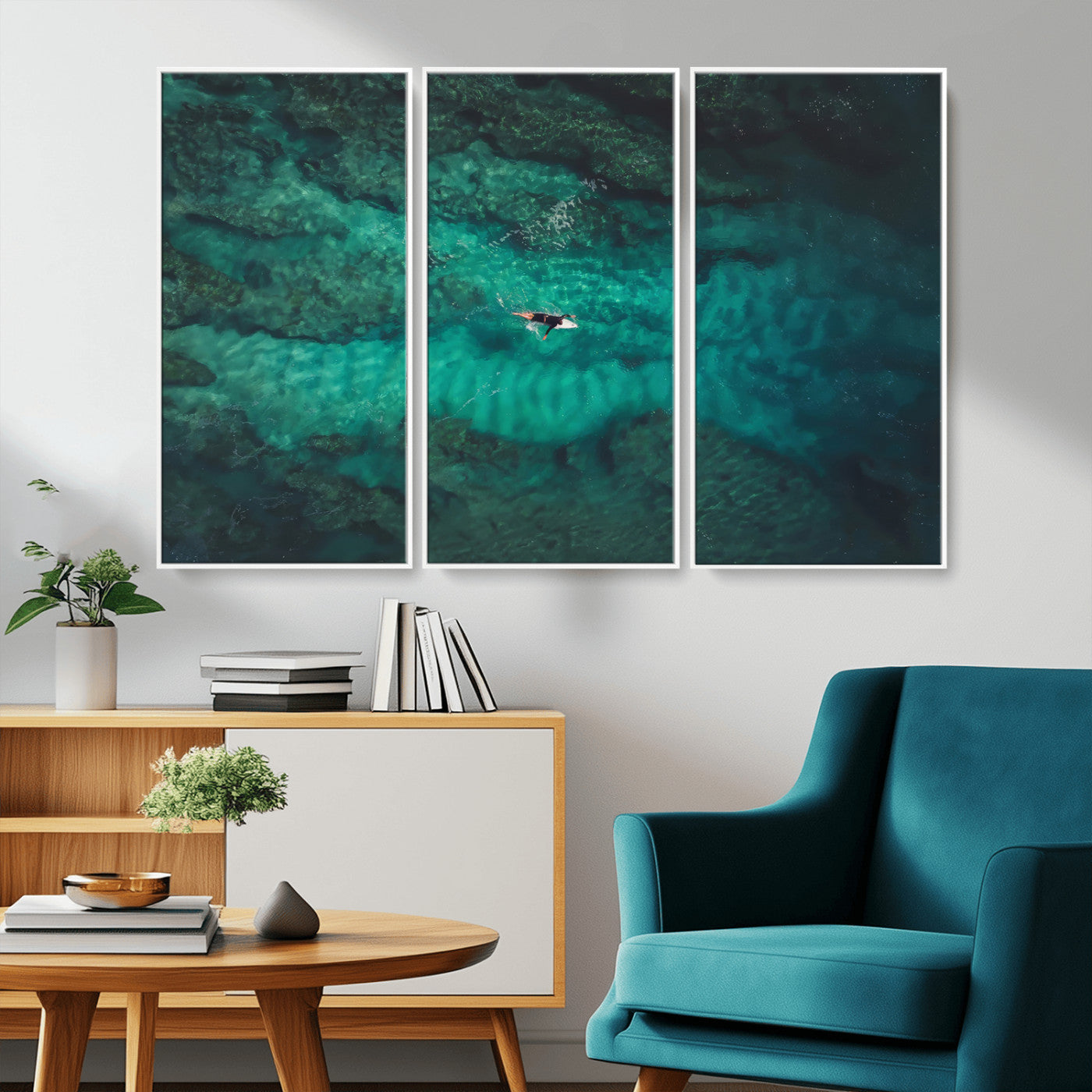 An aerial view of a solo surfer paddling through crystal-clear turquoise waters over a sunlit reef, capturing the beauty and serenity of open water surfing.