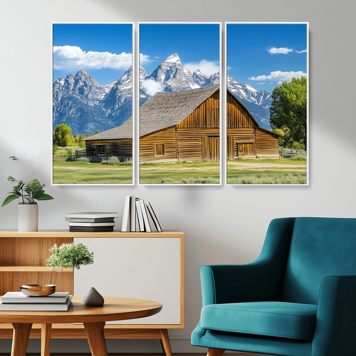 A rustic wooden barn sits in front of towering mountain peaks under a clear blue sky, perfect for farmhouse or cabin style interiors.
