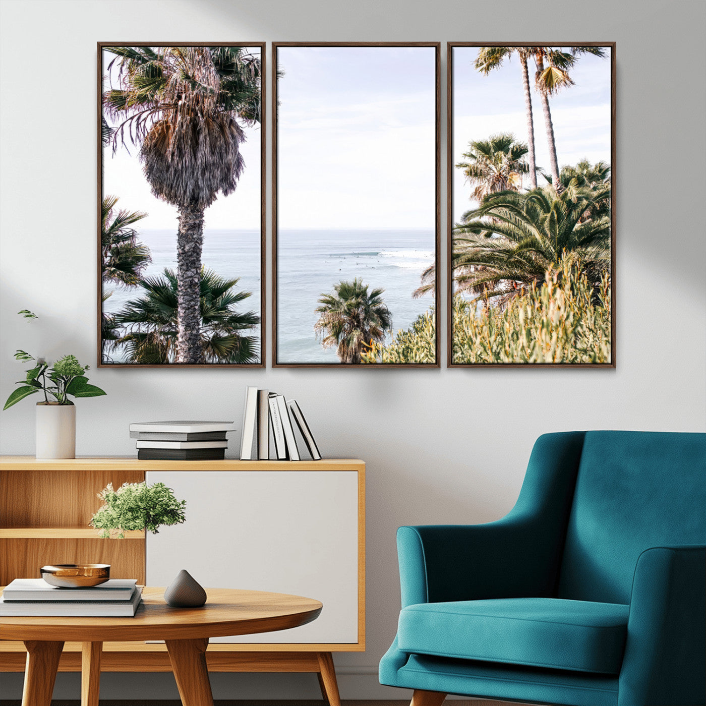 Scenic coastal view with tall palm trees overlooking a calm ocean, soft blue waves, and surfers in the distance, creating a peaceful tropical vibe.