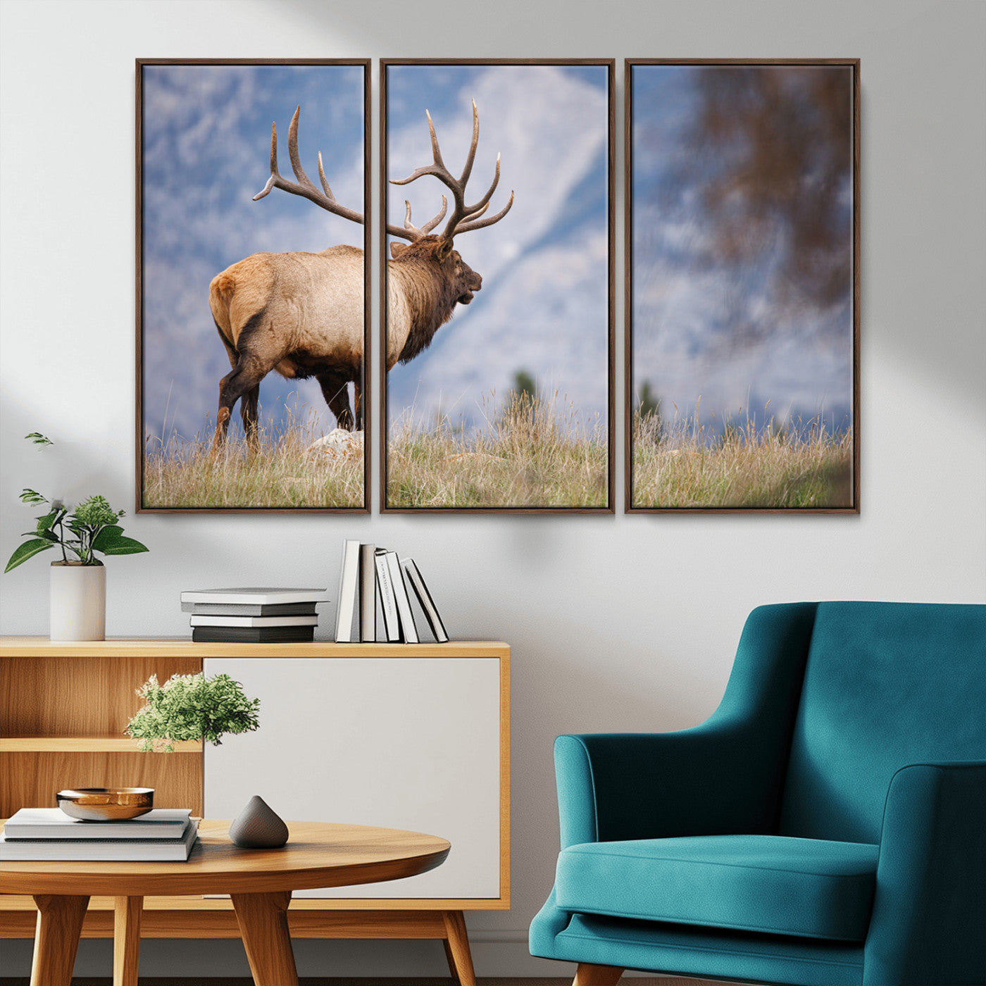 Elk with antlers standing on grass with mountain background, ideal for rustic, cabin, or lodge-inspired wall decor.
