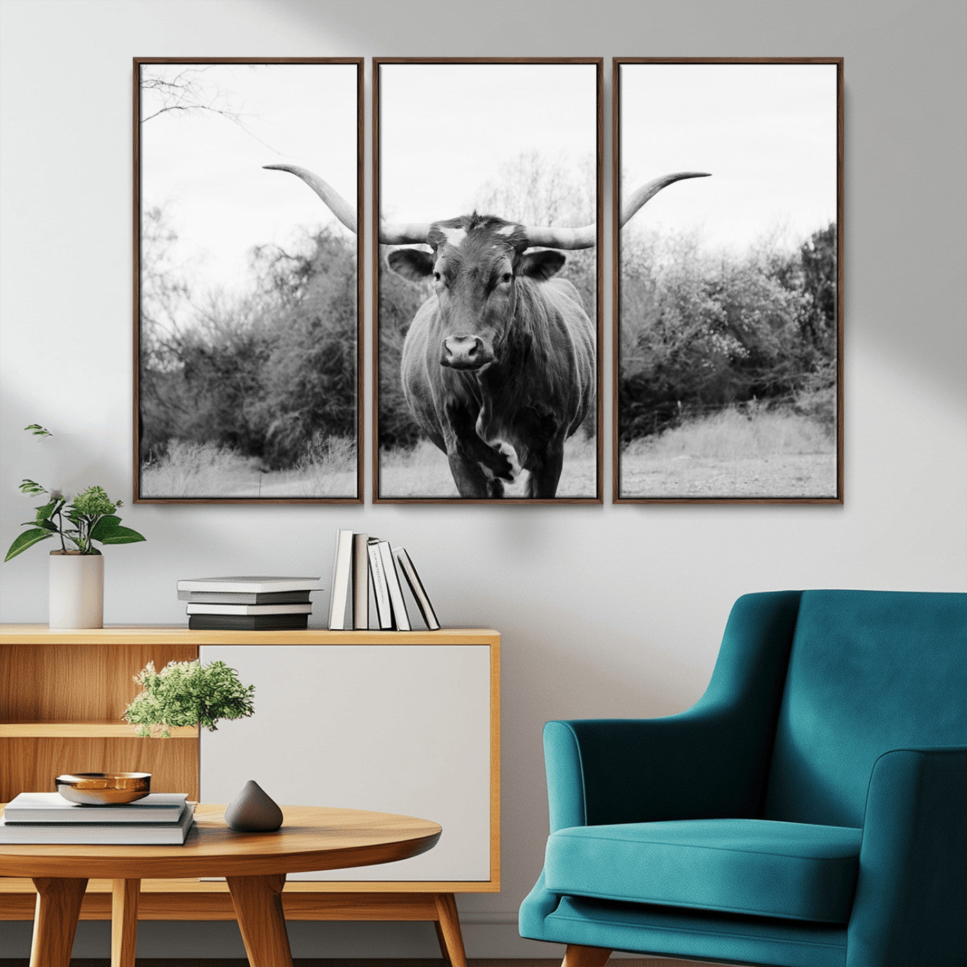 Black and white photo of a longhorn cow in a field, perfect for rustic farmhouse or western-themed interior wall decoration.