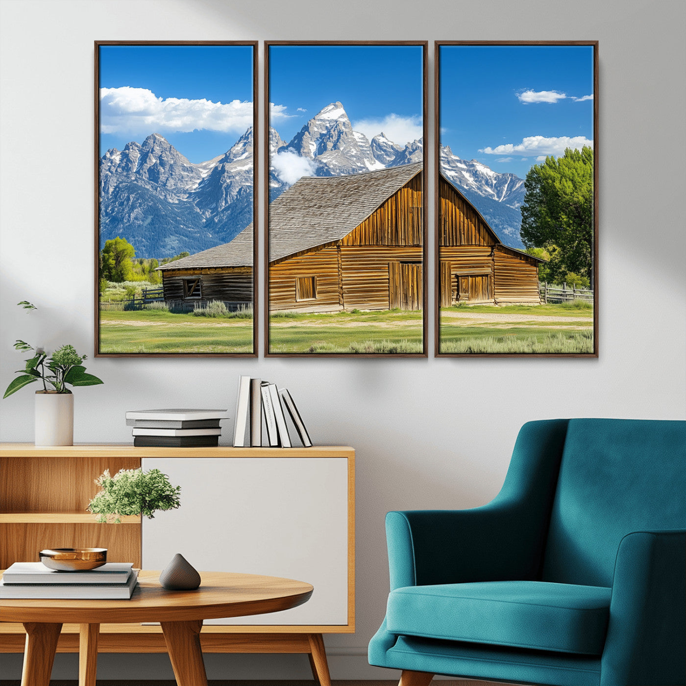 A rustic wooden barn sits in front of towering mountain peaks under a clear blue sky, perfect for farmhouse or cabin style interiors.