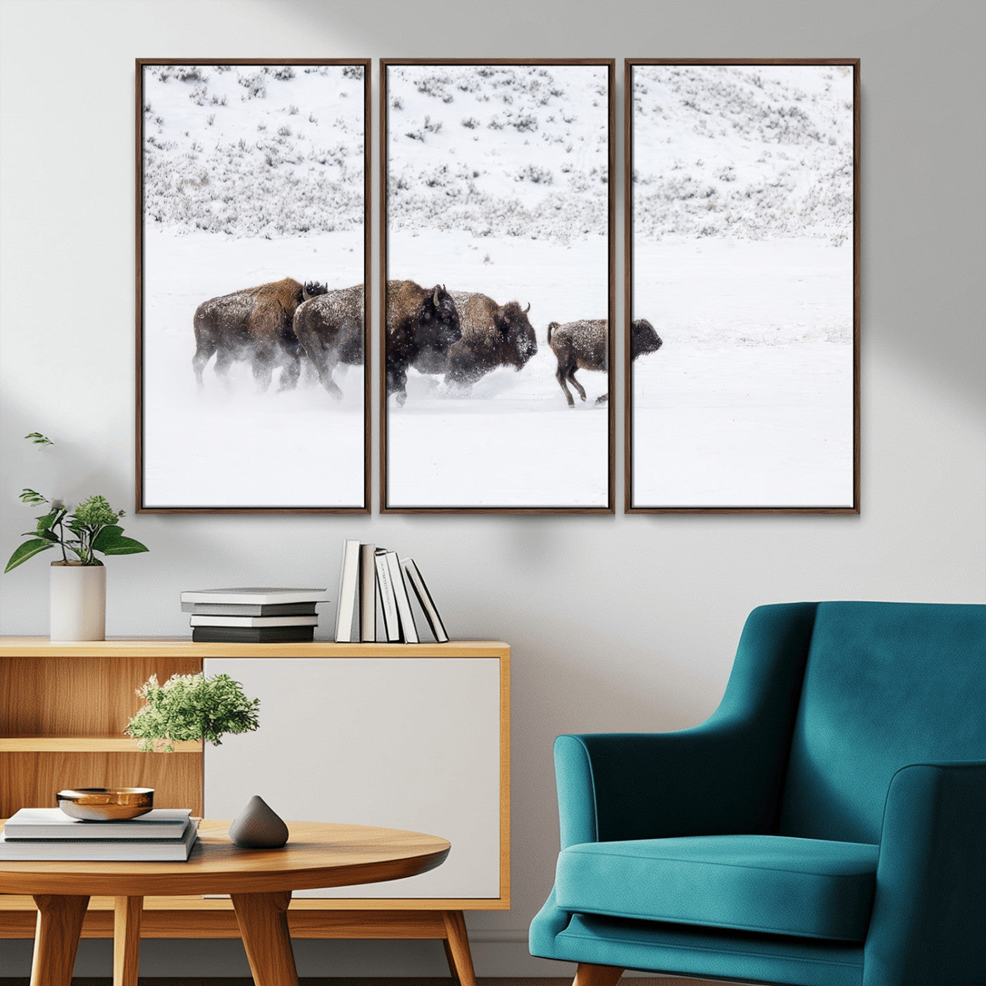 Bison herd running through a snowy open field with mountain backdrop, perfect for rustic or western-themed wall decoration.