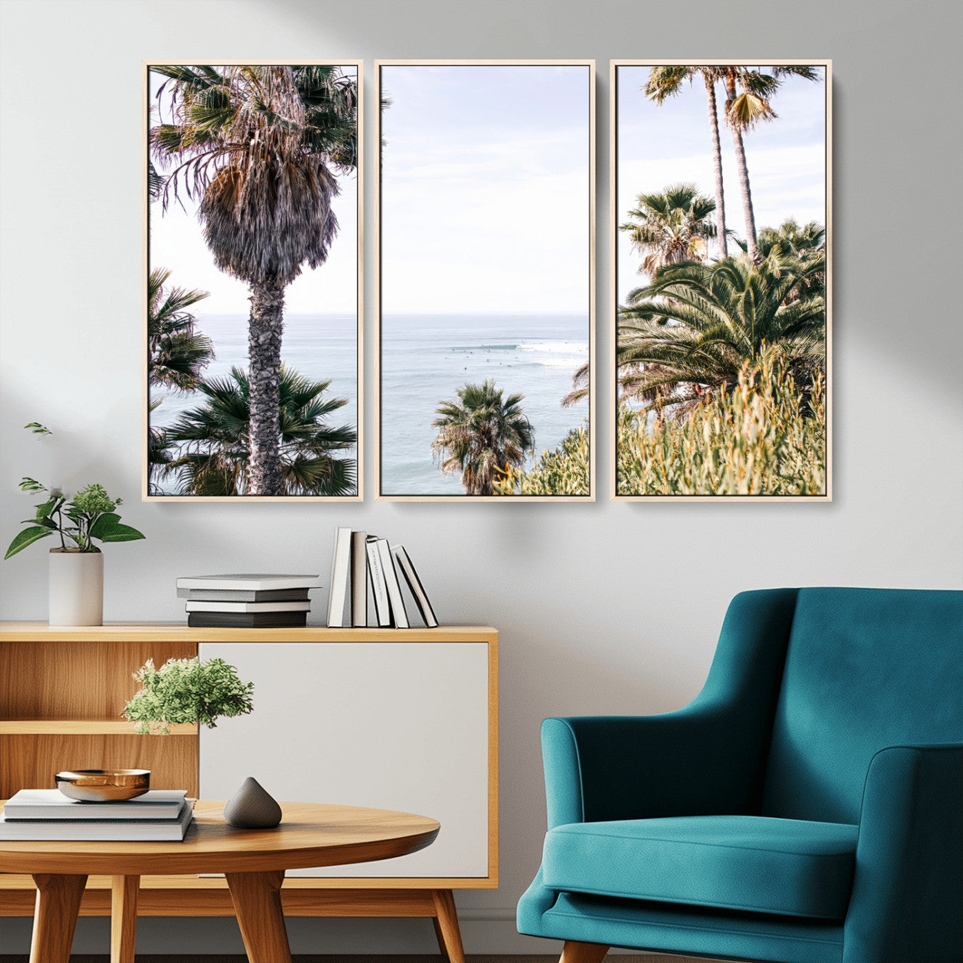 Scenic coastal view with tall palm trees overlooking a calm ocean, soft blue waves, and surfers in the distance, creating a peaceful tropical vibe.
