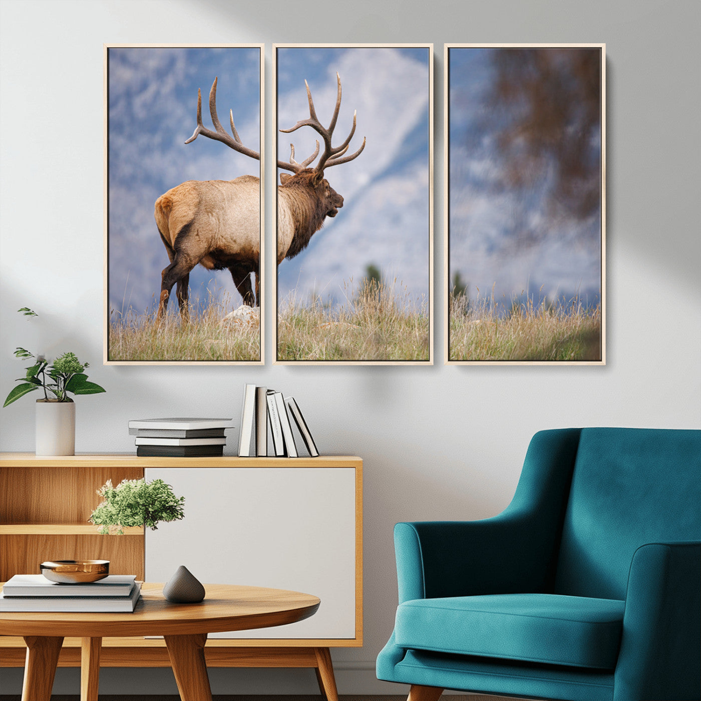 Elk with antlers standing on grass with mountain background, ideal for rustic, cabin, or lodge-inspired wall decor.