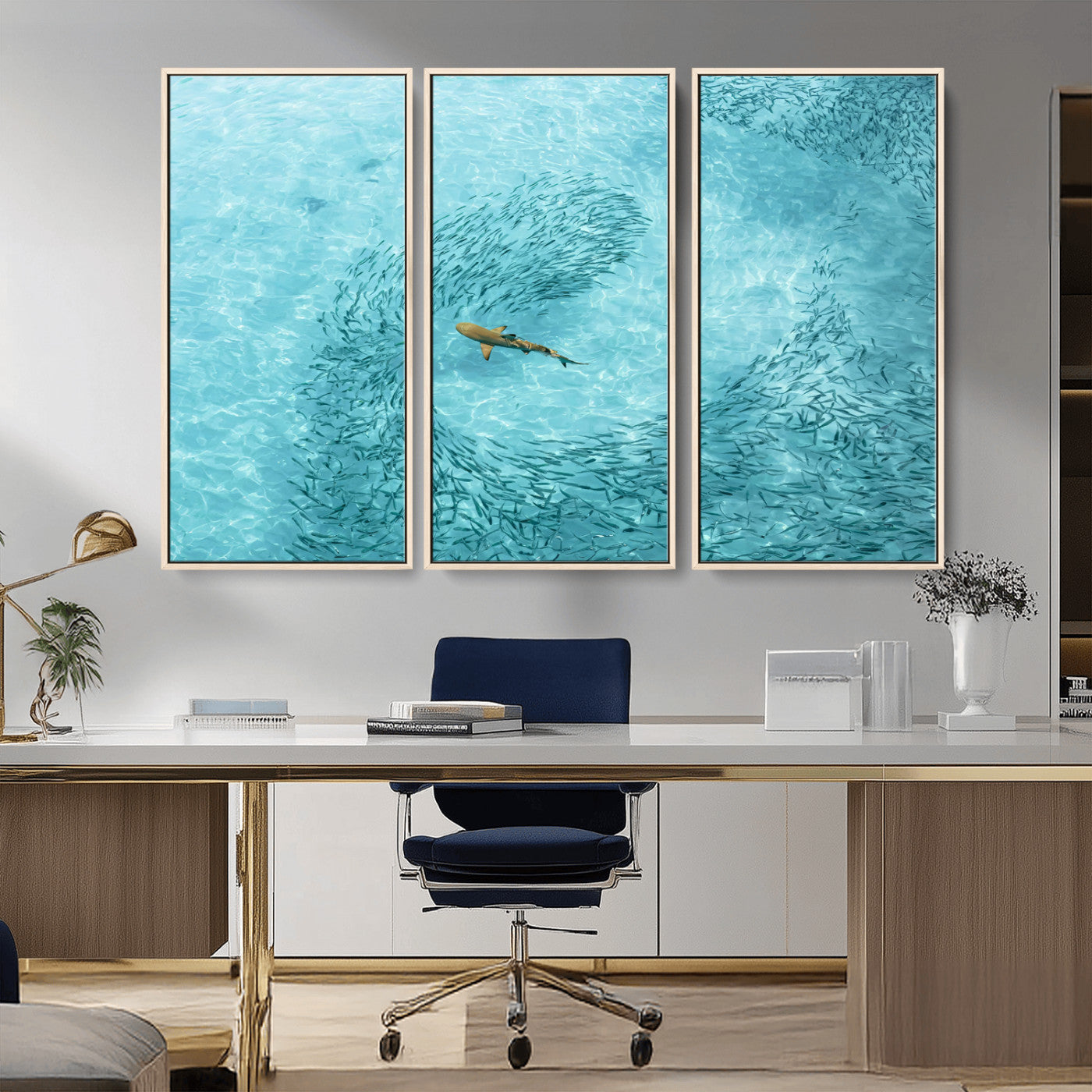 Aerial view of a shark swimming through a swirl of fish in clear turquoise waters, perfect for calm coastal or beach house decor.