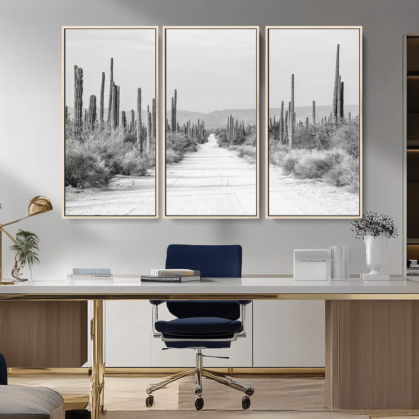 A black and white desert road stretching through a cactus-filled landscape, creating a rugged and timeless southwestern aesthetic with a sense of adventure.