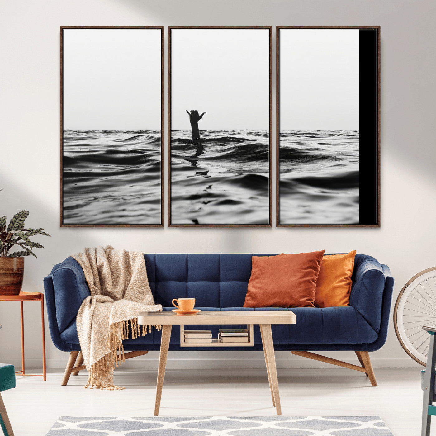 Black and white ocean with a hand making a surfer sign among dark waves, creating a dramatic and minimalist seascape with bold contrast.
