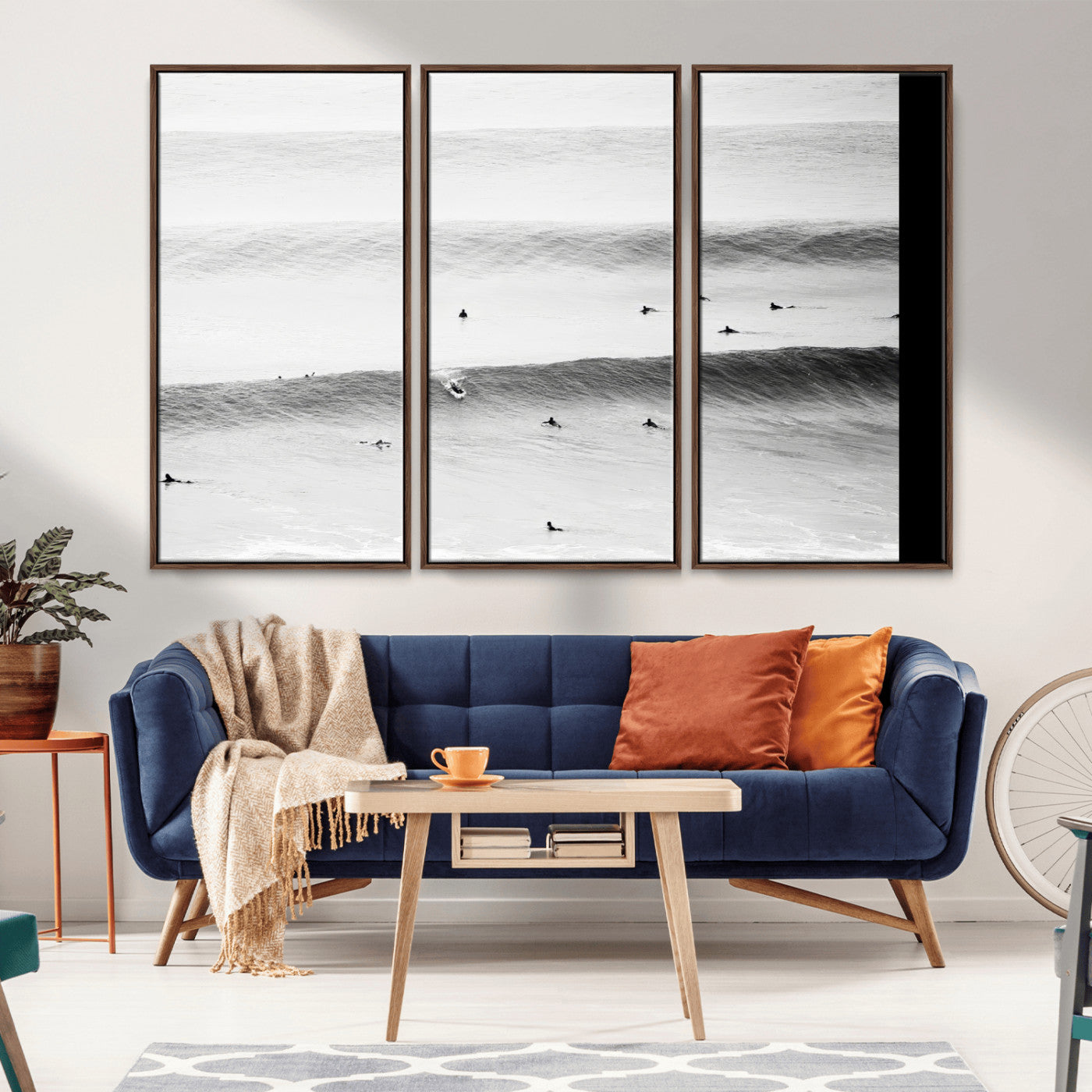 A monochrome photograph of swimmers gliding through gentle ocean waves, evoking a sense of calm and movement.