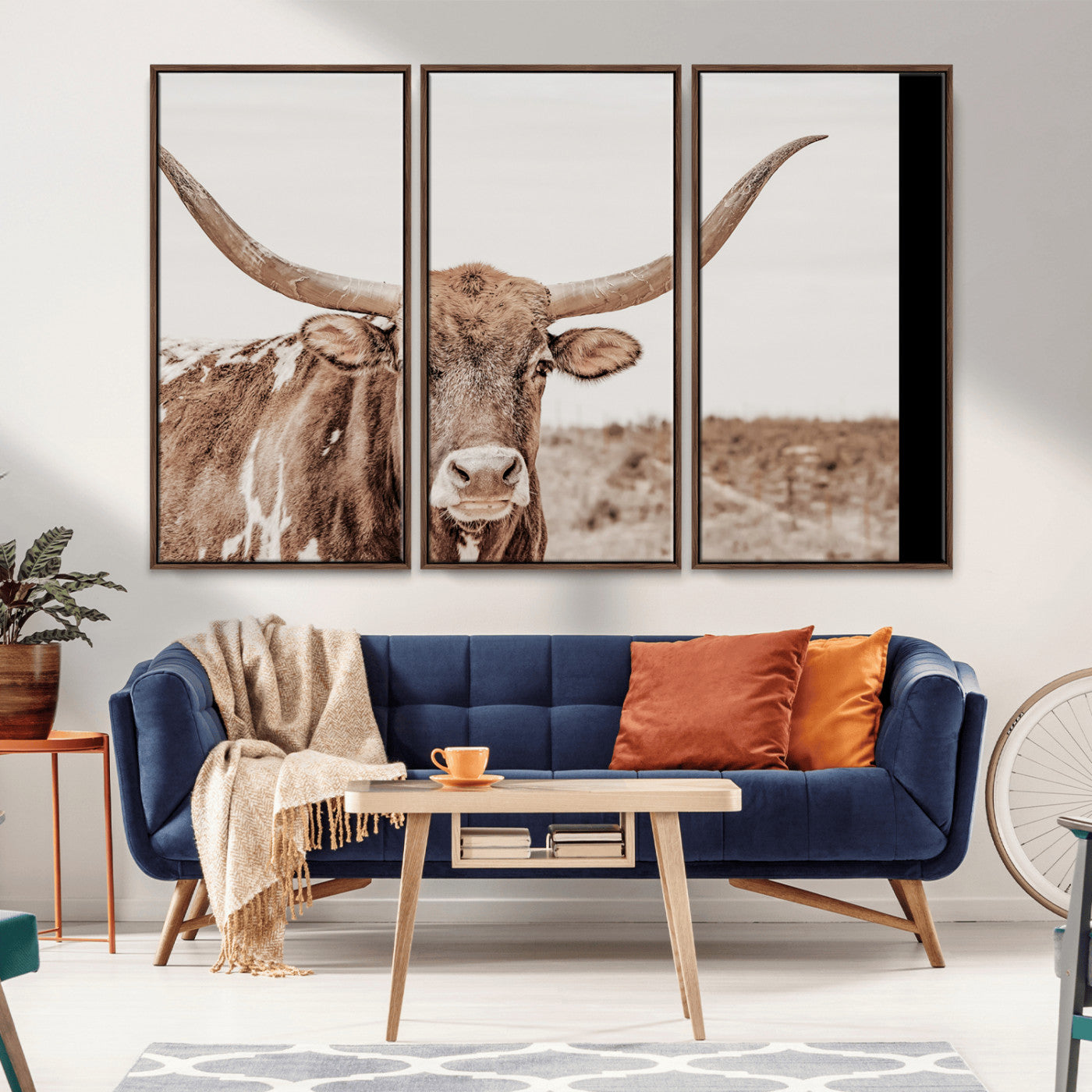A longhorn cow in soft beige desert tones, standing calmly in open land, perfect for neutral western or rustic farmhouse interiors.