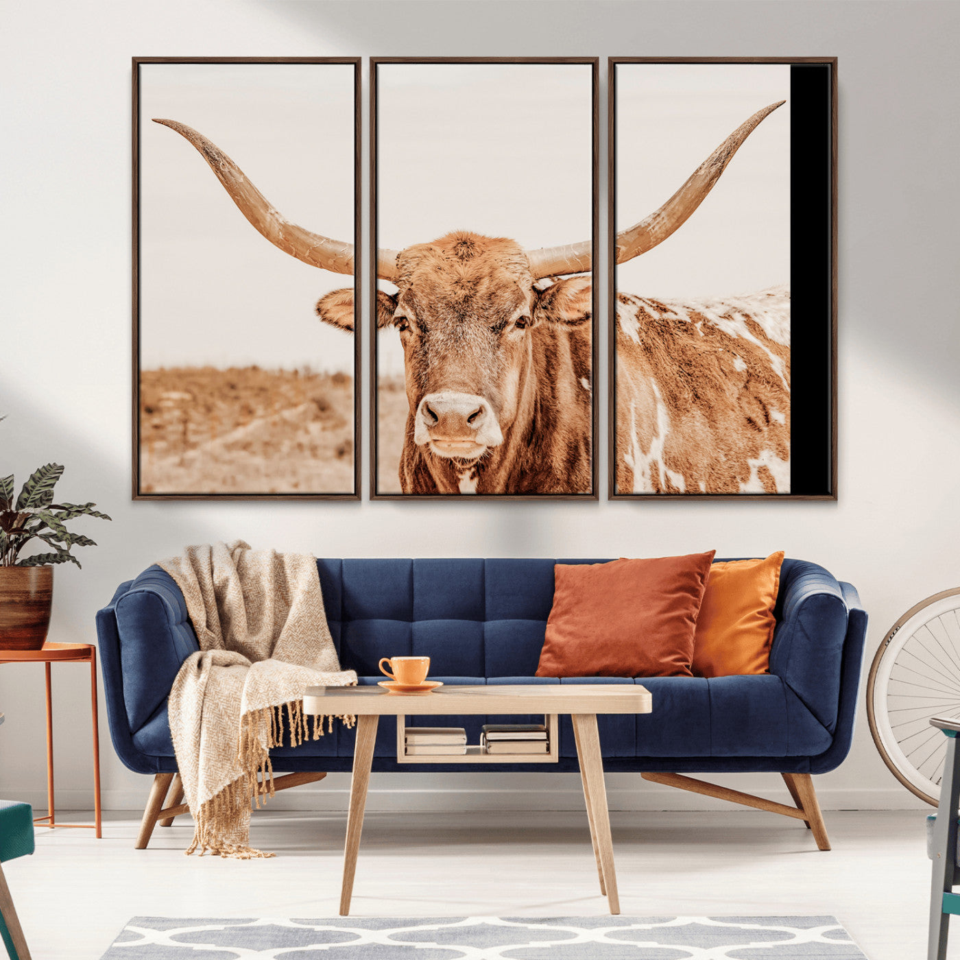 A longhorn bull standing proudly in a sunlit desert field with warm neutral tones, ideal for rustic western or farmhouse interiors.
