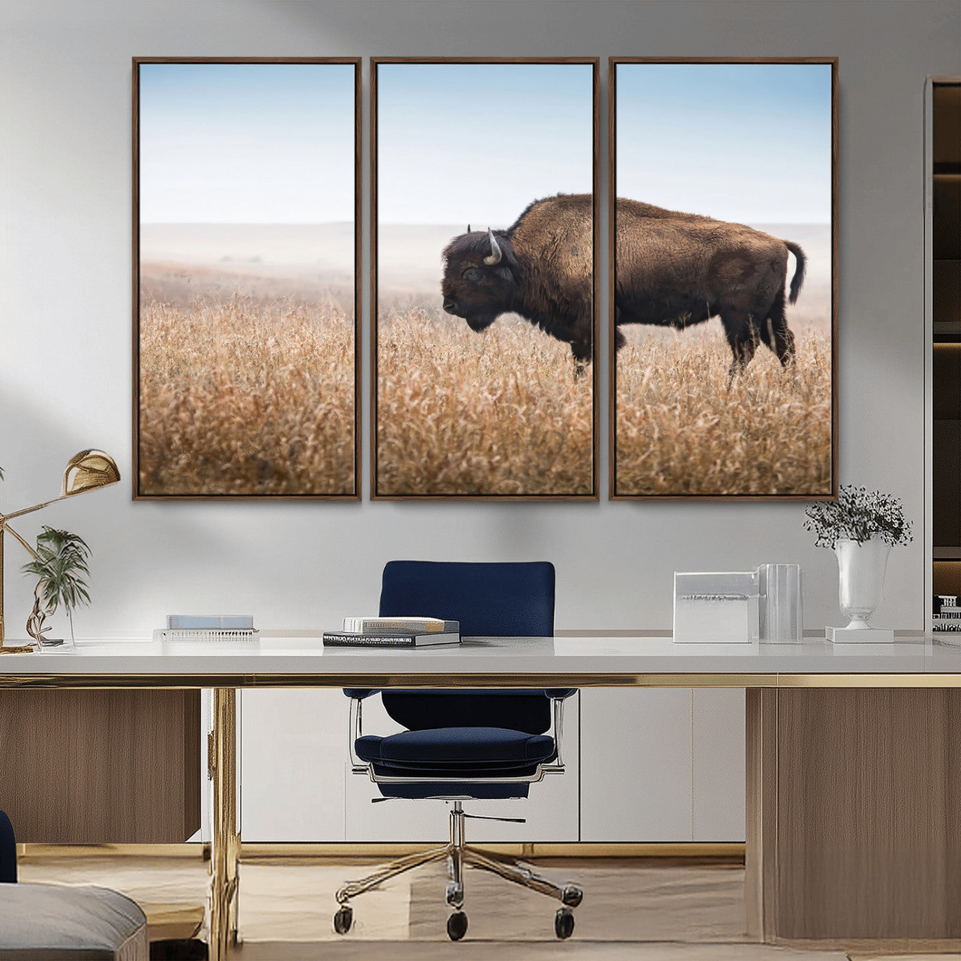A majestic bison standing in an open prairie field, its strong form blending into the golden grass under a vast blue sky, evoking the wild spirit of the American plains.