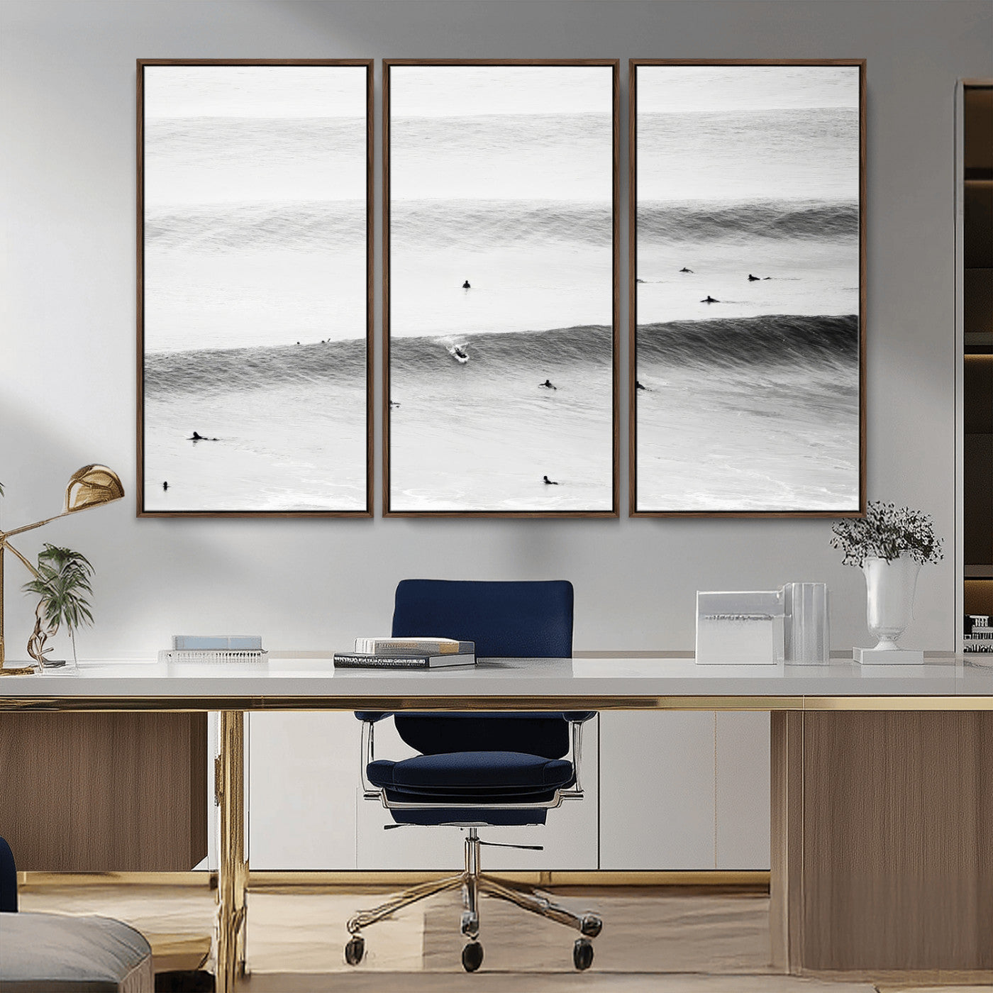 A monochrome photograph of swimmers gliding through gentle ocean waves, evoking a sense of calm and movement.