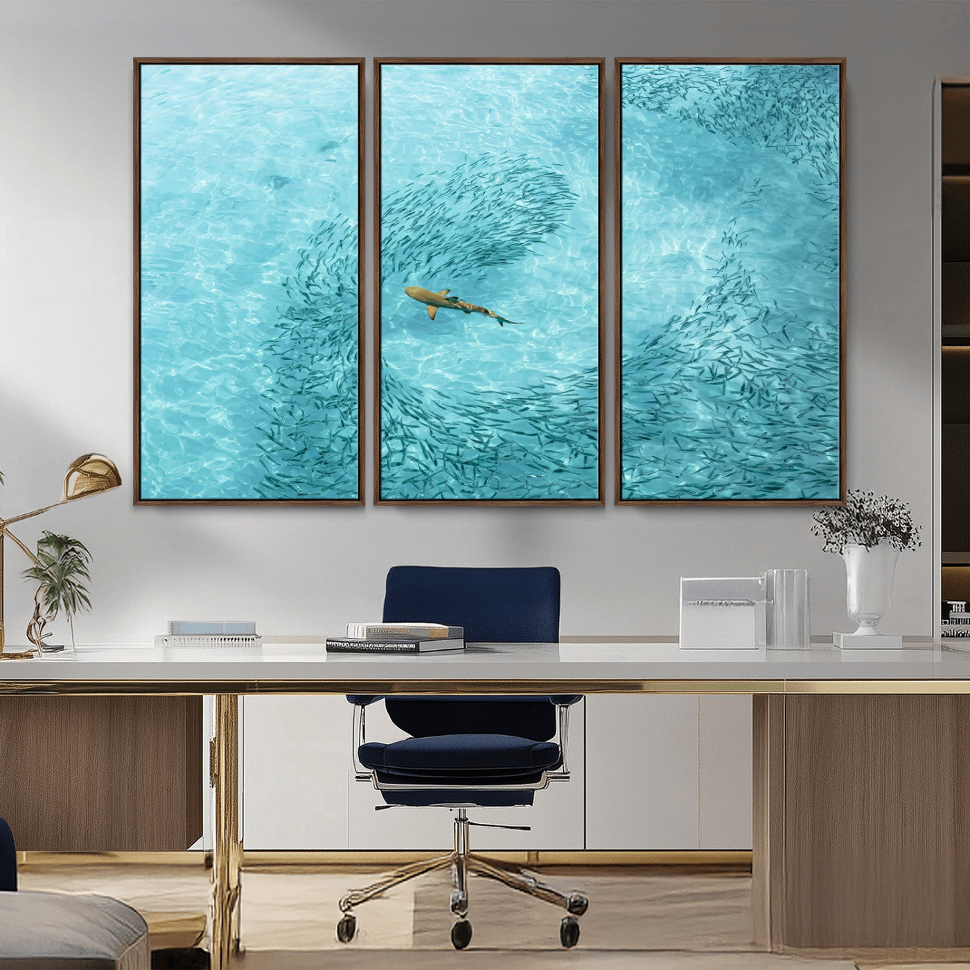 Aerial view of a shark swimming through a swirl of fish in clear turquoise waters, perfect for calm coastal or beach house decor.
