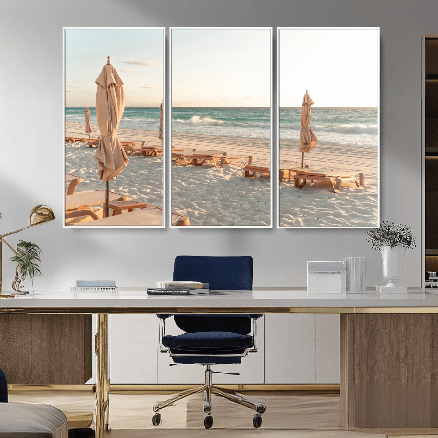 Minimalist photo of empty beach loungers and umbrellas on soft sand, ideal for calm seaside or pastel coastal-style home decor.