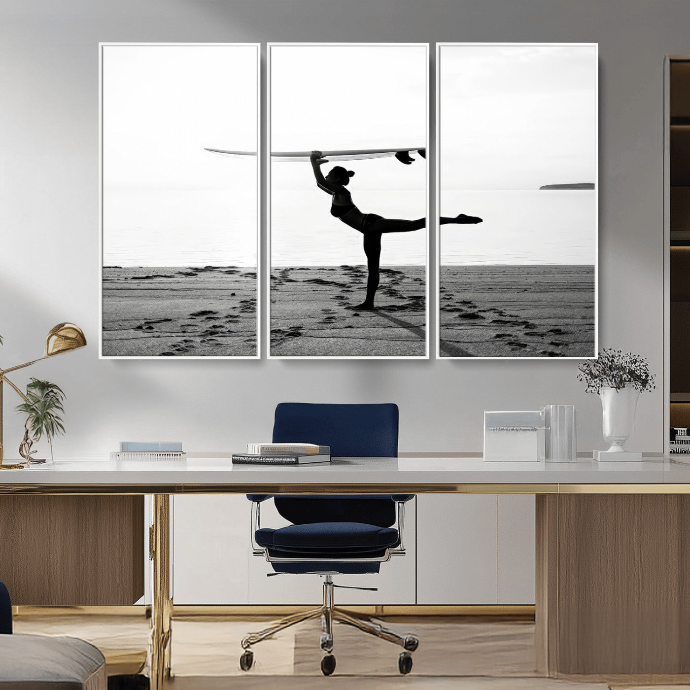 A woman balances a surfboard on her head while striking a yoga pose on the beach, silhouetted against a calm ocean horizon.