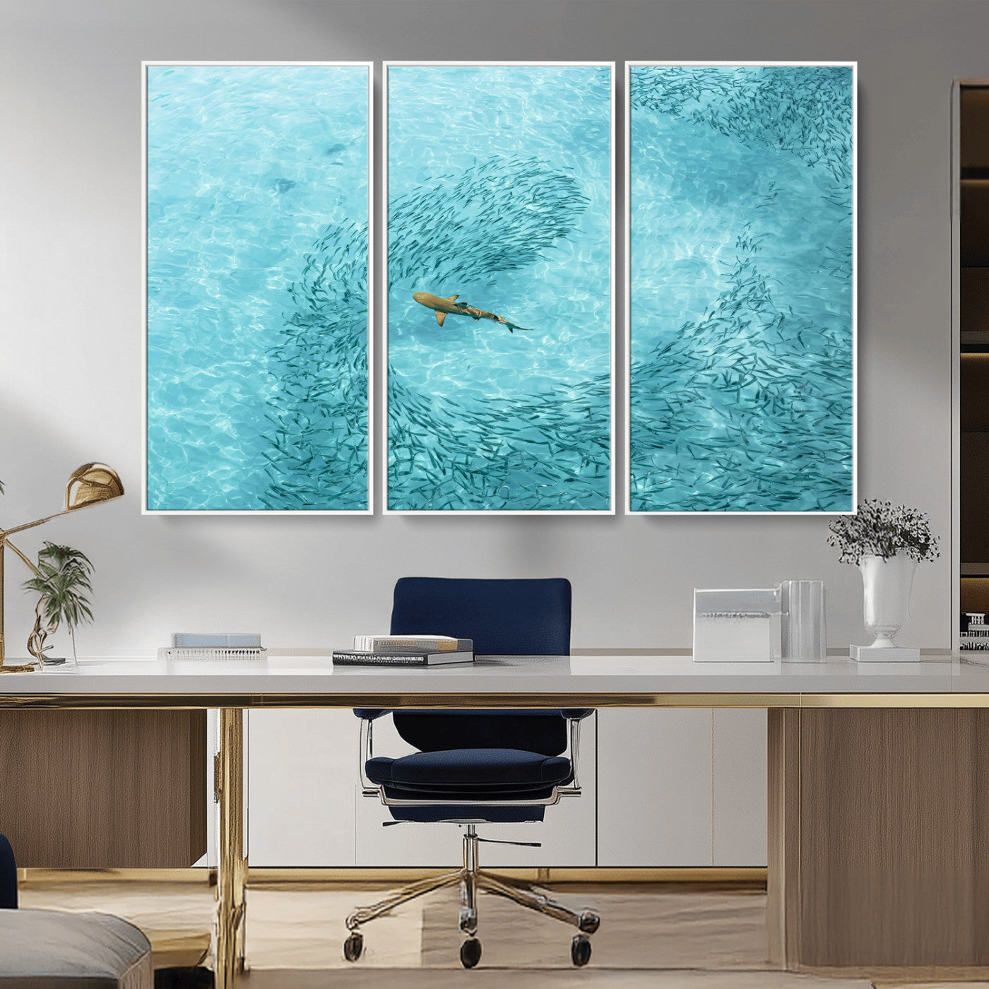 Aerial view of a shark swimming through a swirl of fish in clear turquoise waters, perfect for calm coastal or beach house decor.