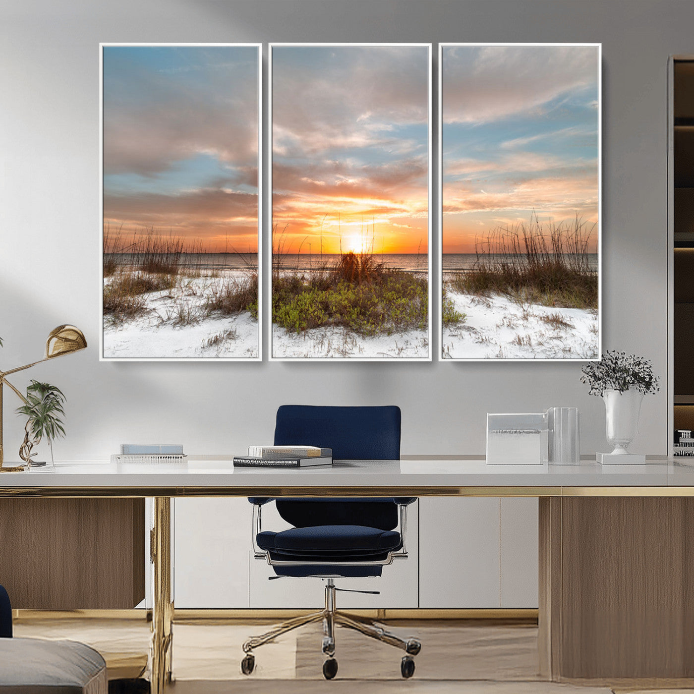 A tranquil beach scene featuring golden sunset hues over the water, with grasses in the foreground and a peaceful, serene atmosphere.