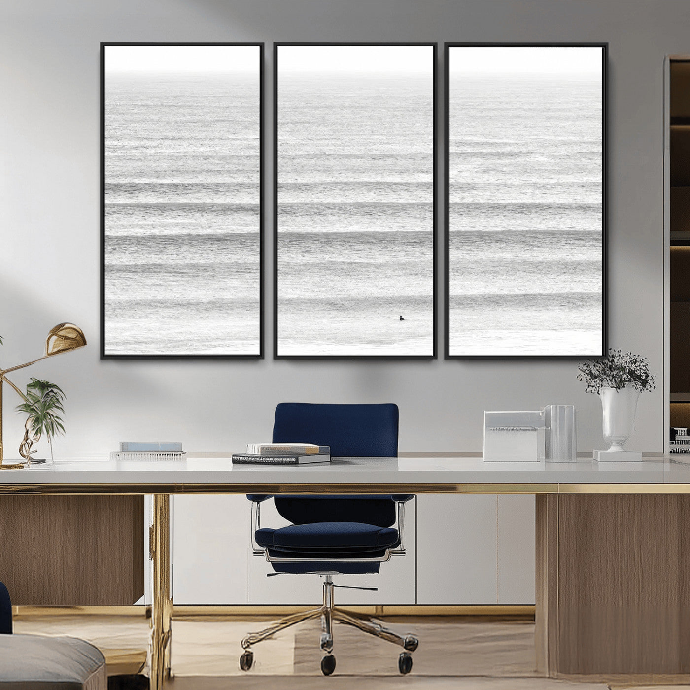 Monochrome photo of a lone surfer in calm layered waves, perfect for minimalist coastal or moody ocean-inspired wall decoration.