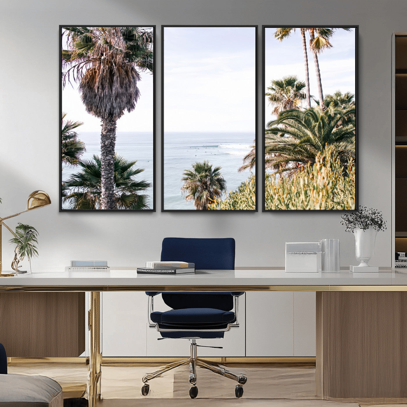 Scenic coastal view with tall palm trees overlooking a calm ocean, soft blue waves, and surfers in the distance, creating a peaceful tropical vibe.