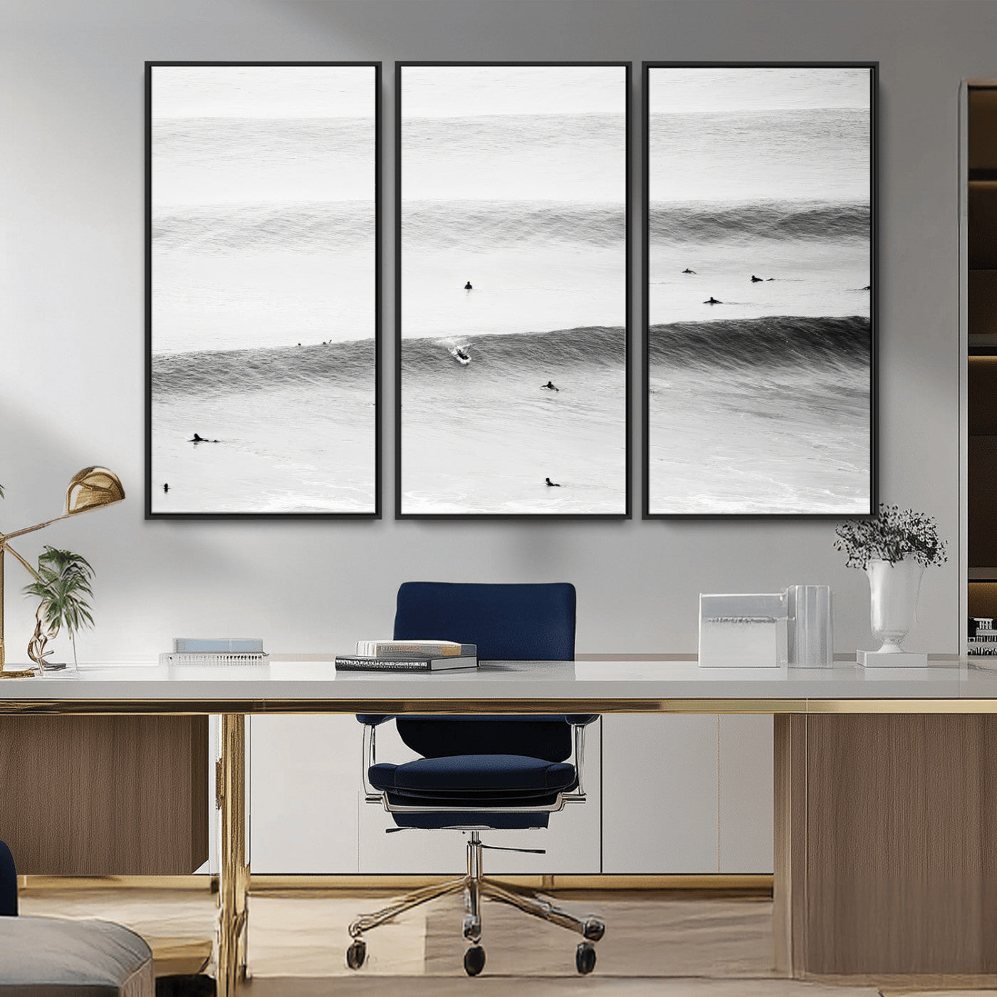 A monochrome photograph of swimmers gliding through gentle ocean waves, evoking a sense of calm and movement.