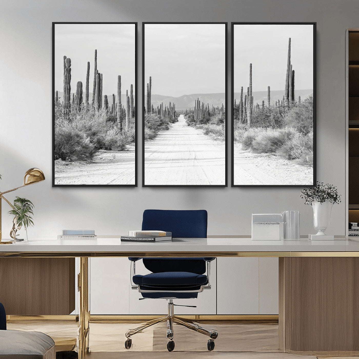 A black and white desert road stretching through a cactus-filled landscape, creating a rugged and timeless southwestern aesthetic with a sense of adventure.